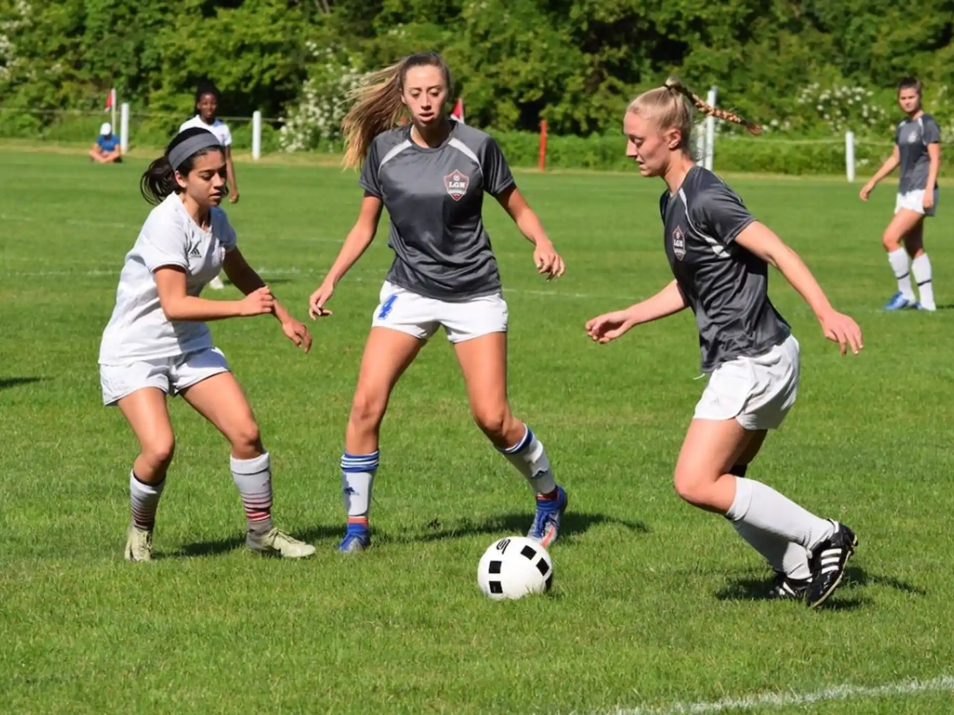 girls playing football on a field