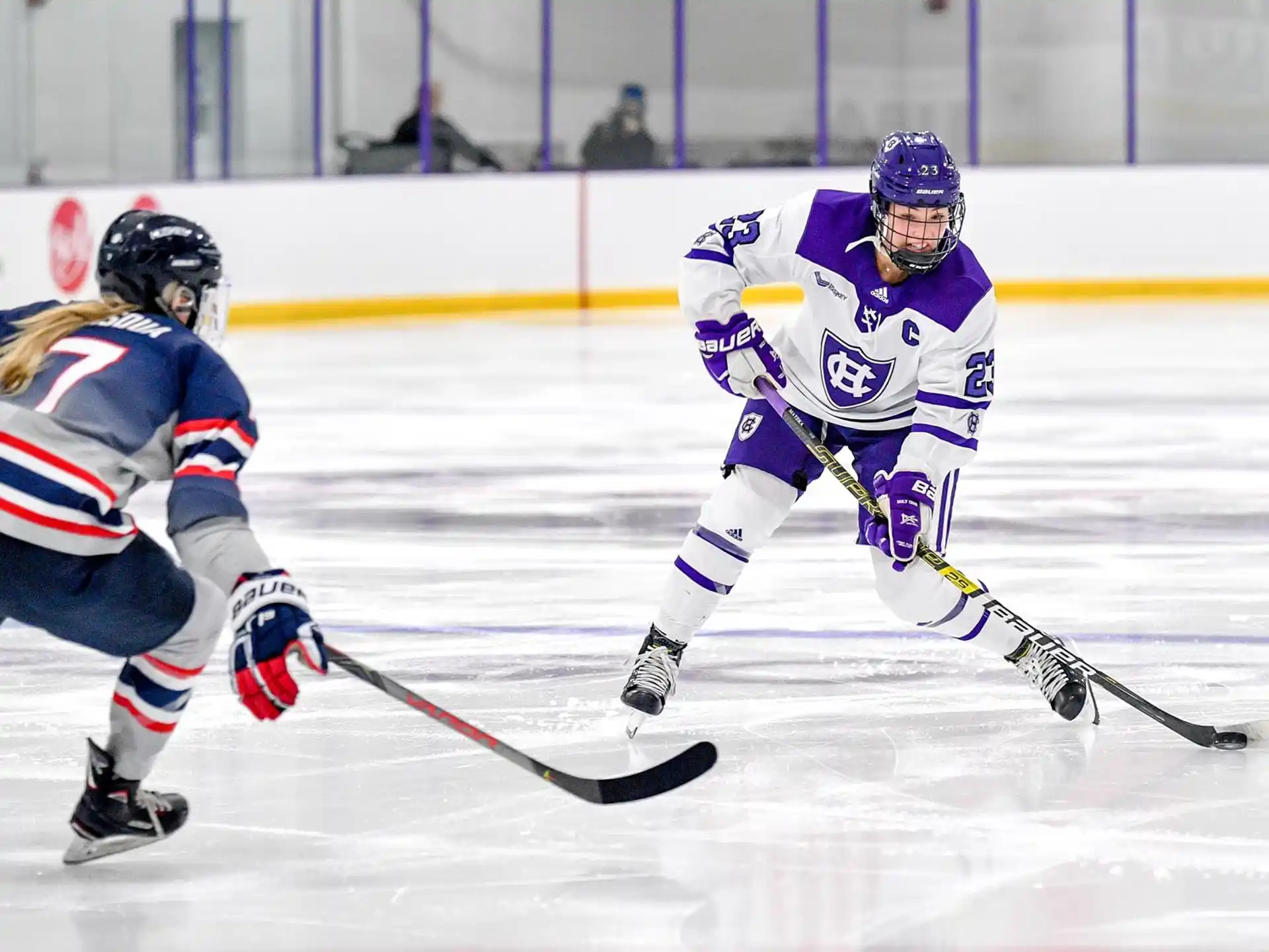 a couple of people playing hockey