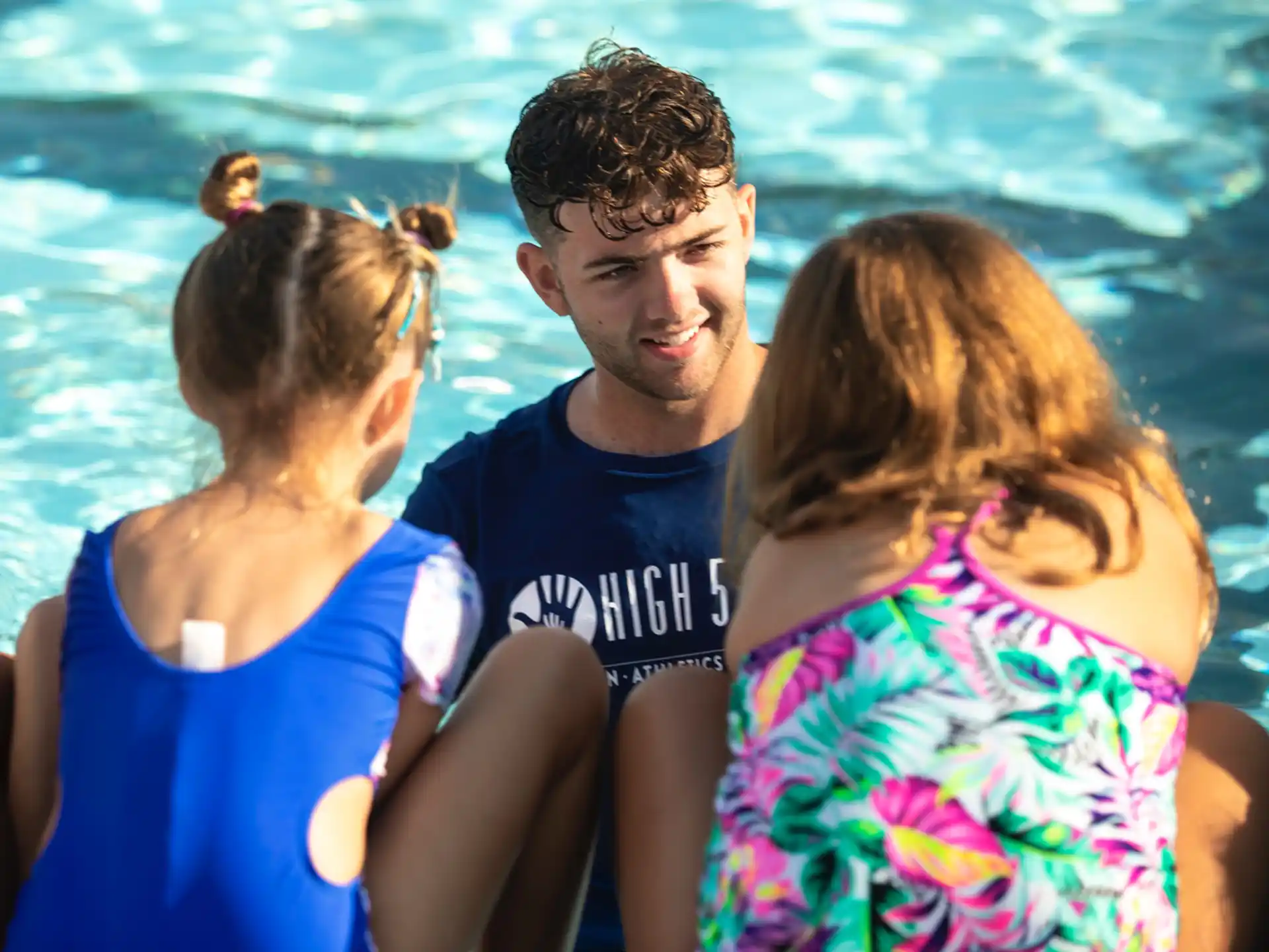 a group of people sitting in a pool