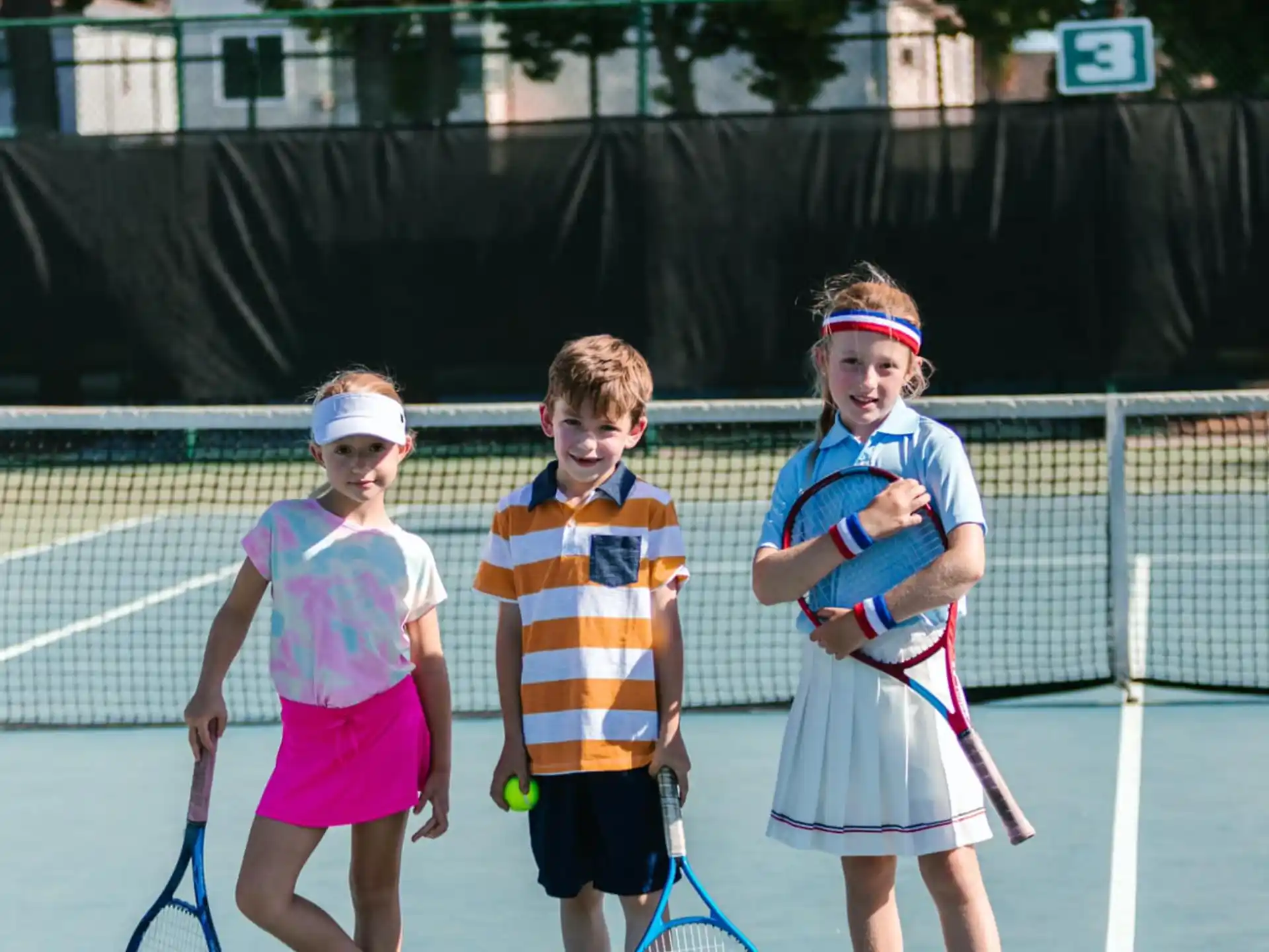 kids holding tennis rackets