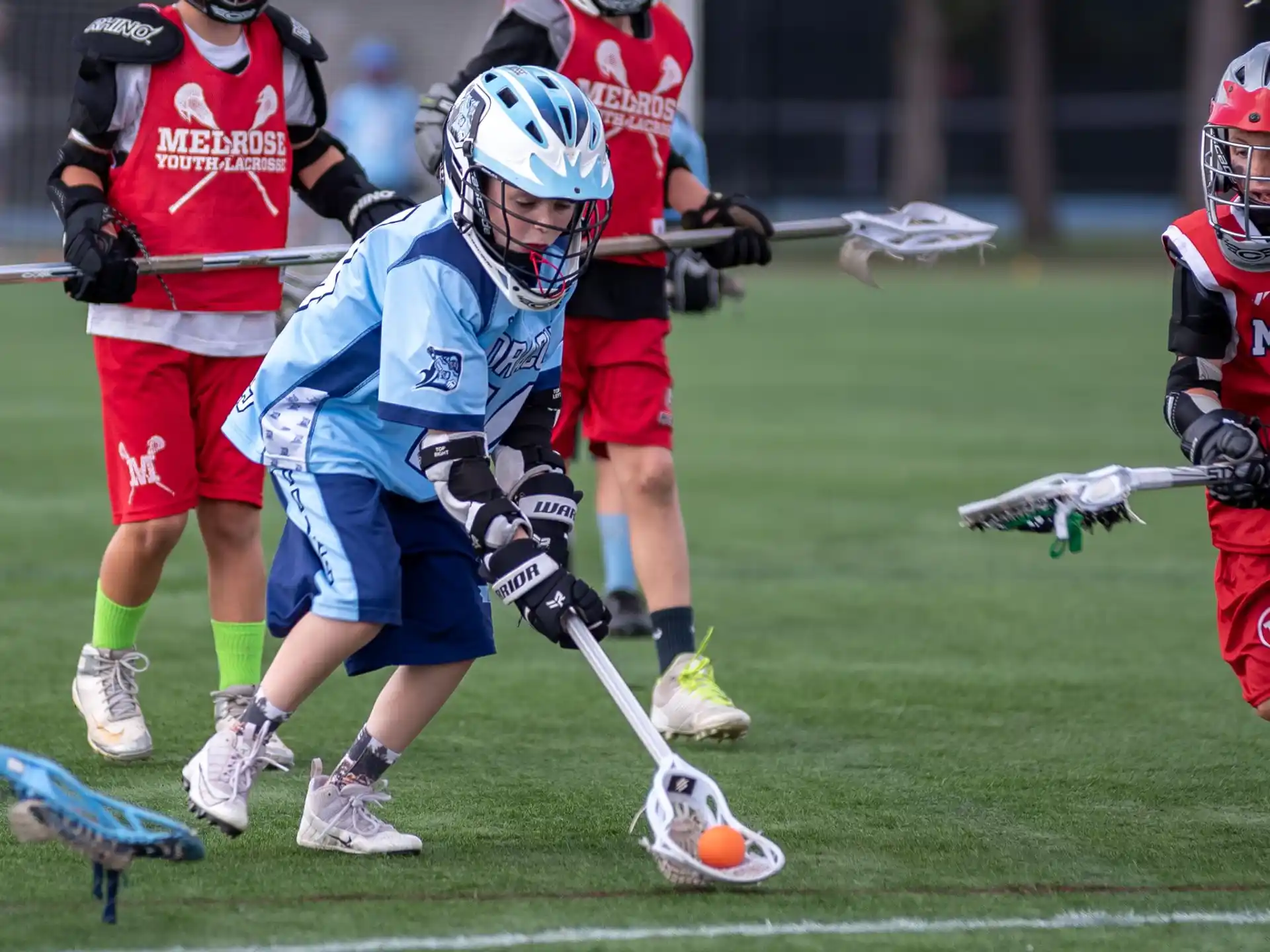 a group of people playing lacrosse
