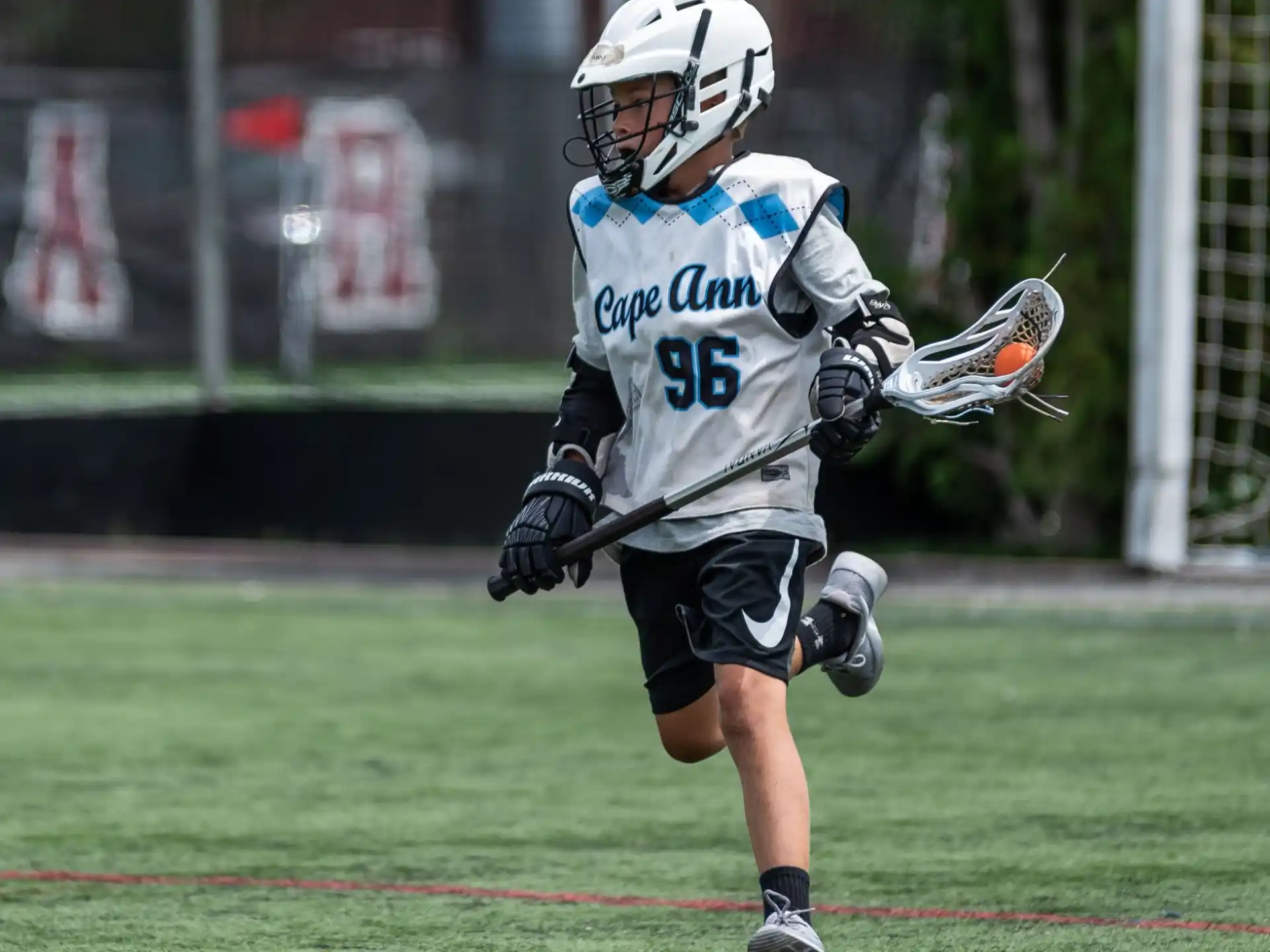 a man wearing a helmet and holding a stick