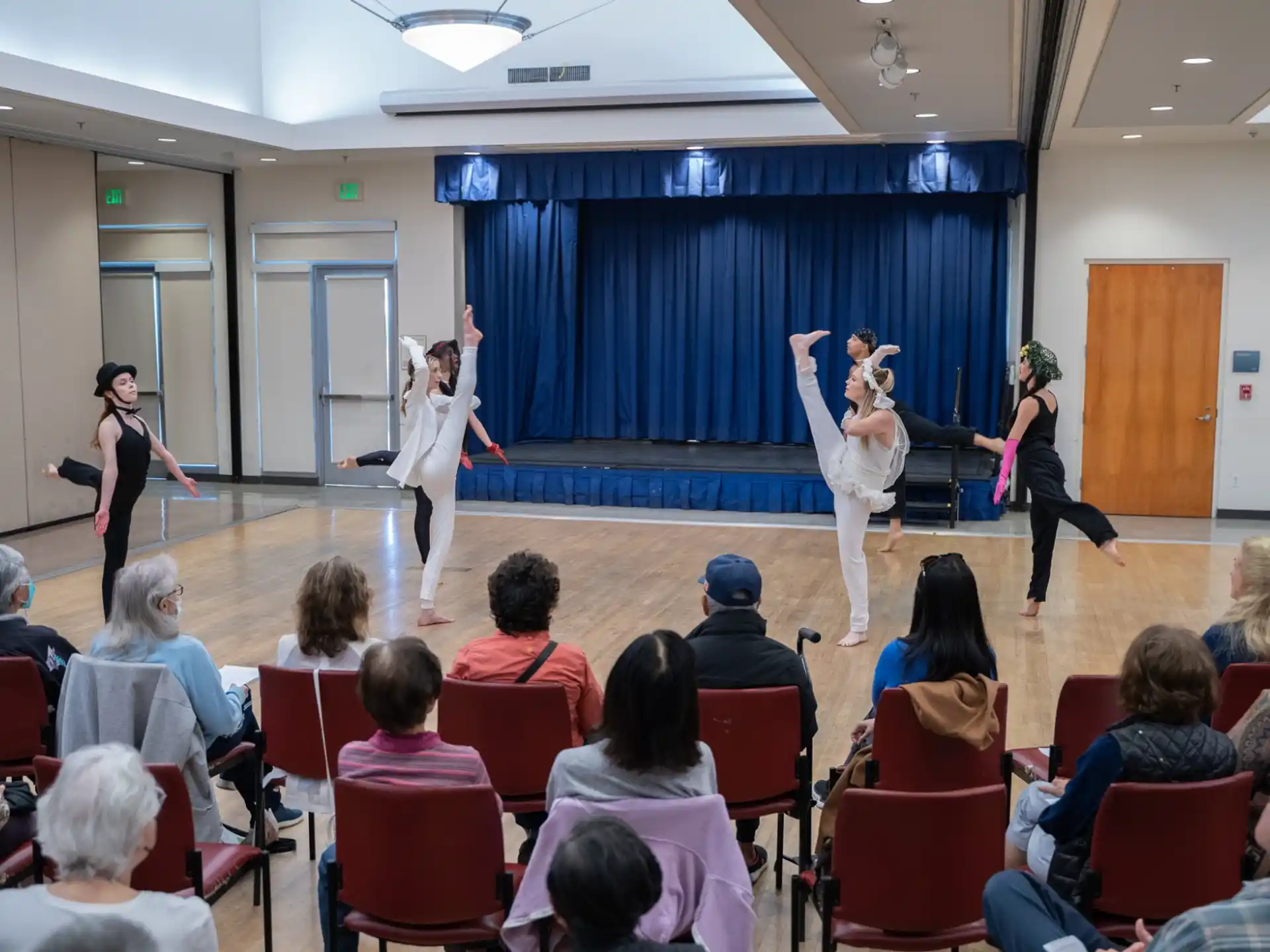 a group of women performing on a stage in front of an audience