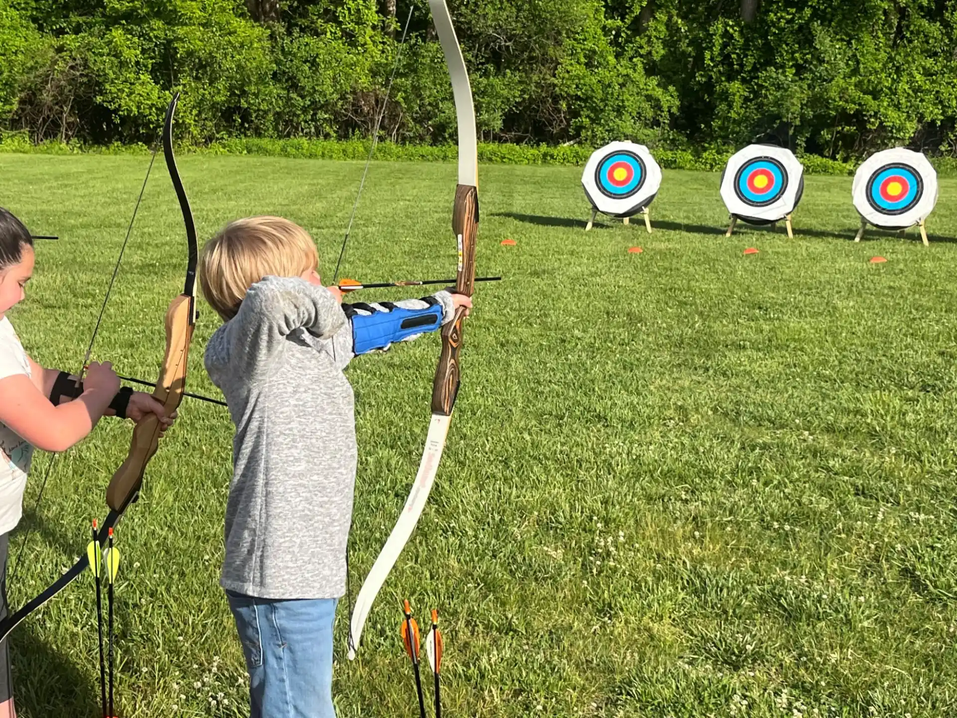 a couple of kids shooting bows