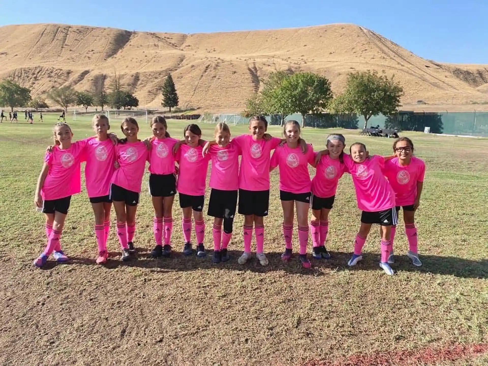 a group of girls in pink shirts