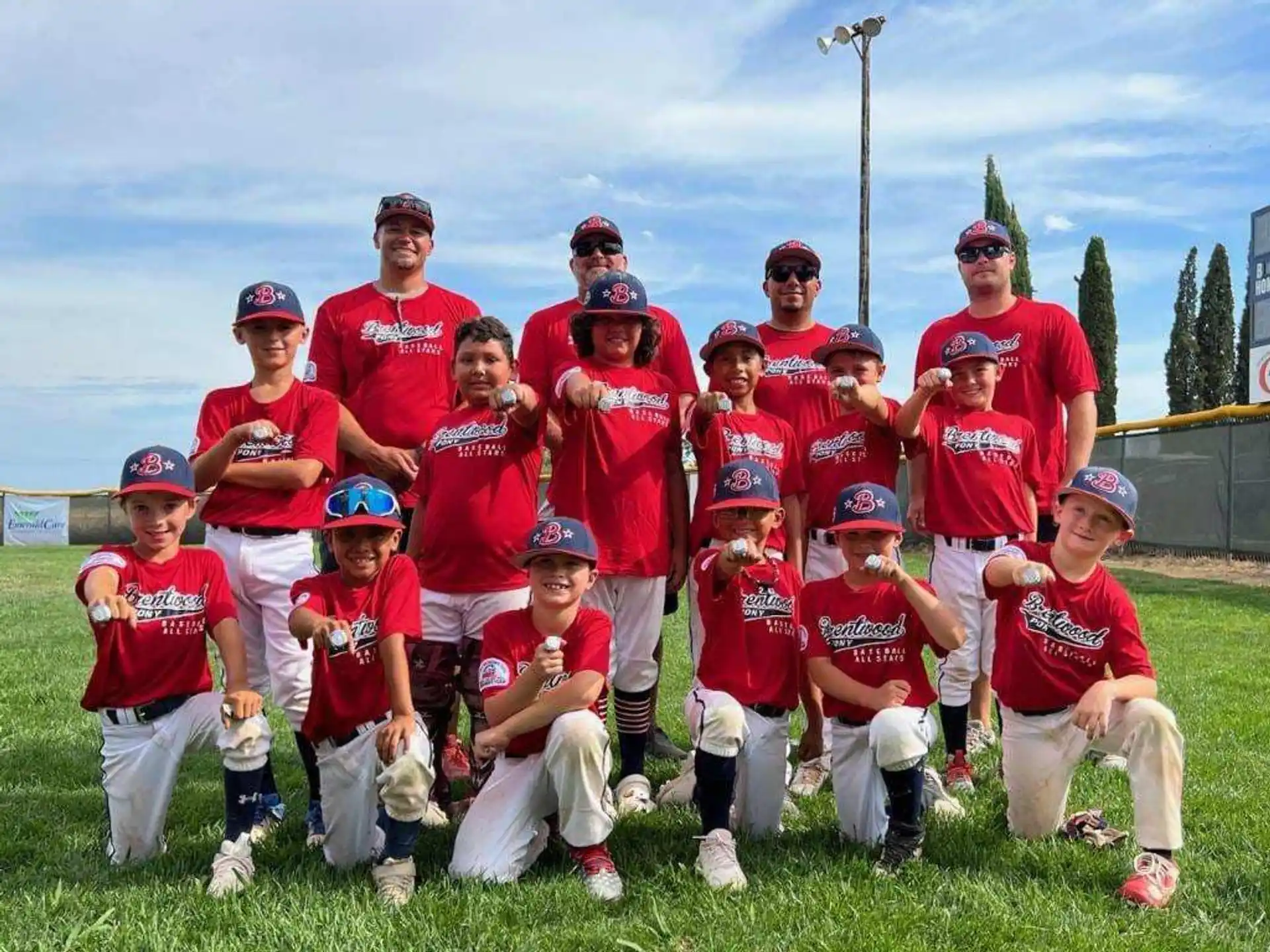 a group of kids wearing red uniforms