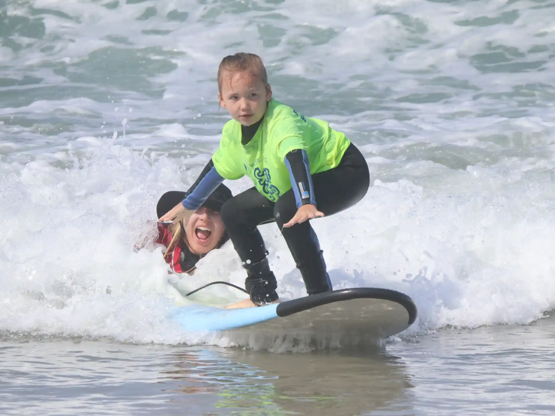 a couple of people surfing in the sea