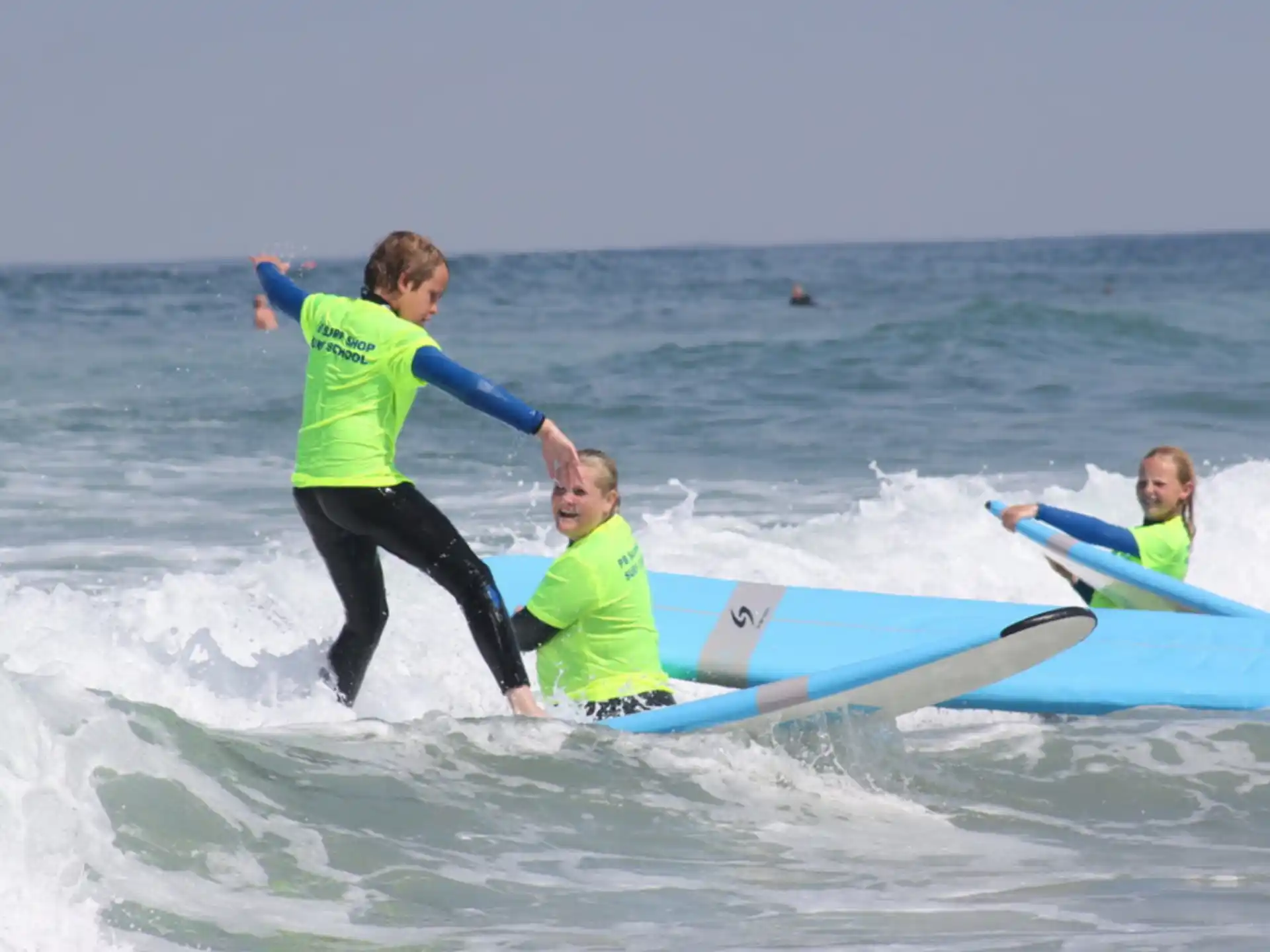 a group of people surfing in the sea