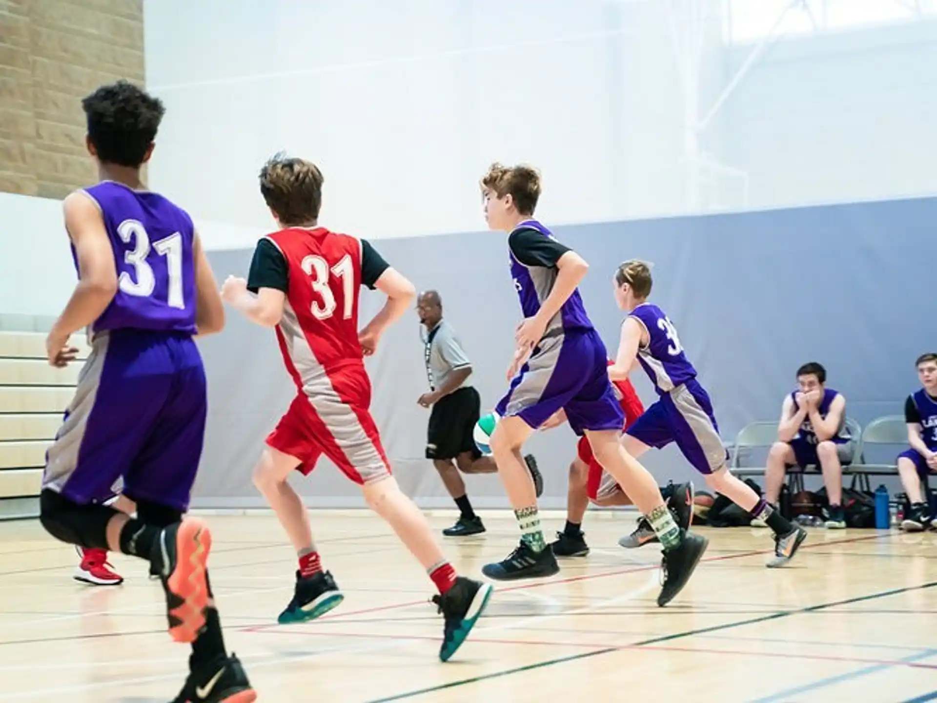 a group of boys playing basketball