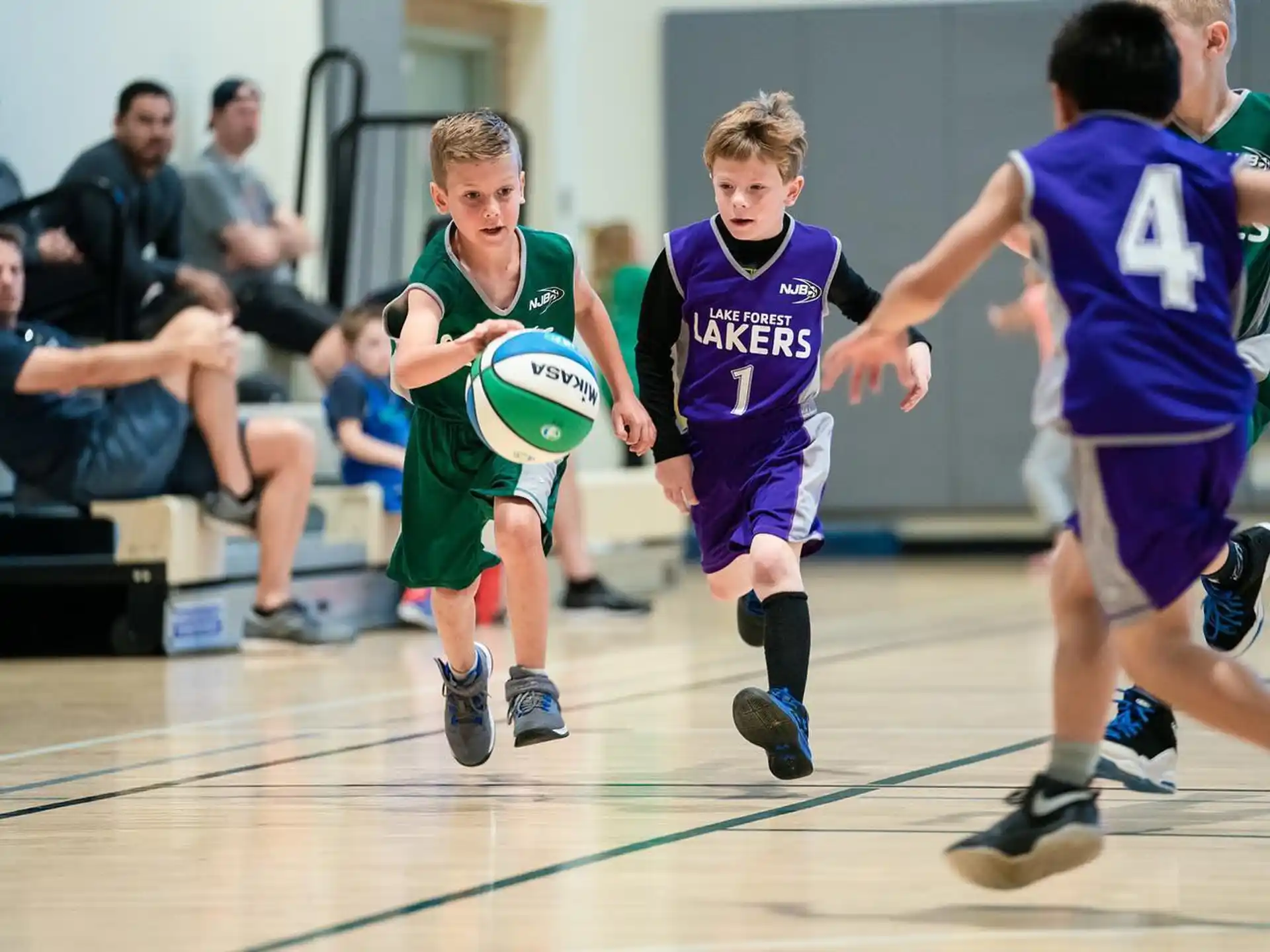 a group of boys playing basketball
