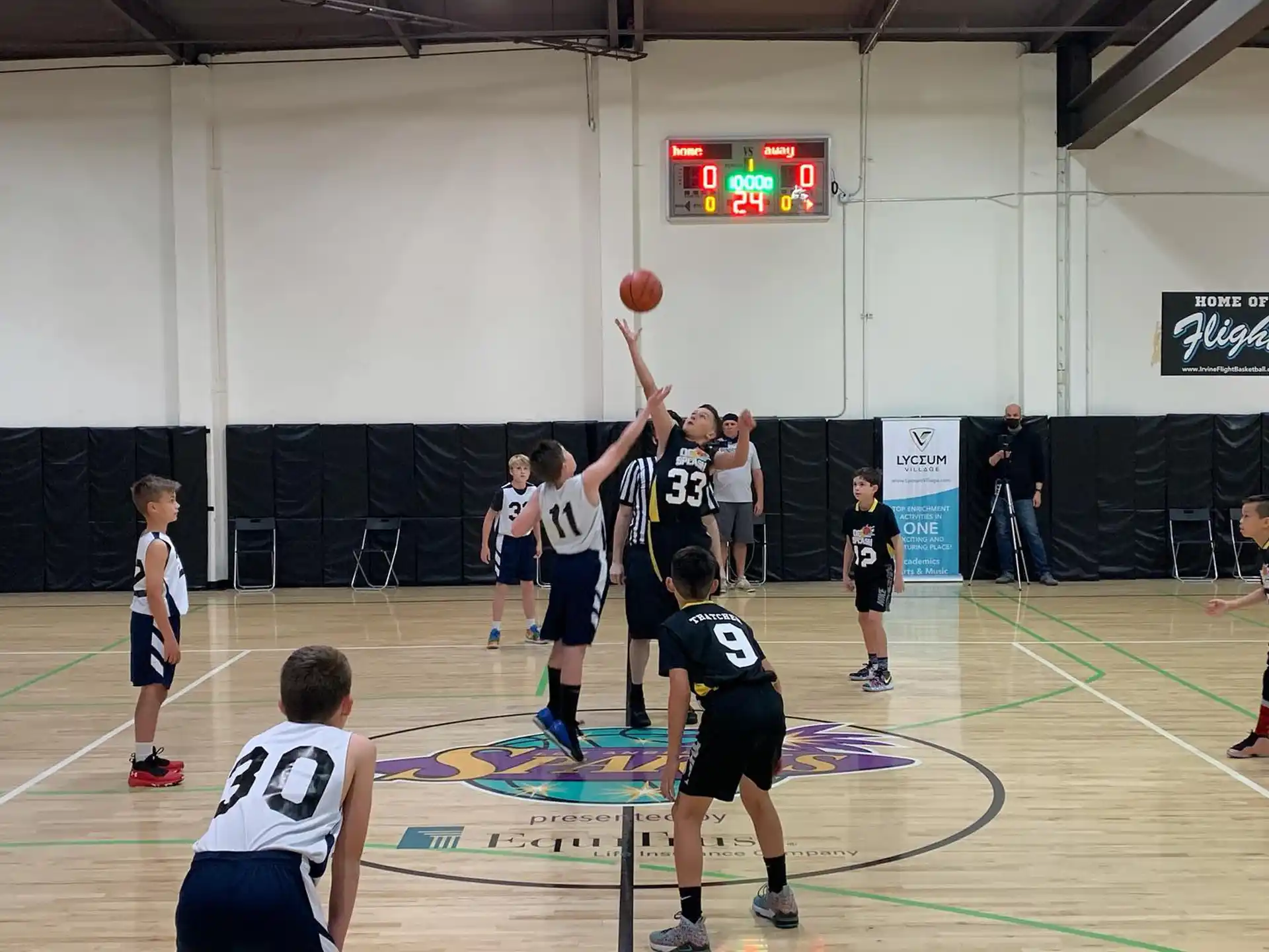 a group of people playing basketball