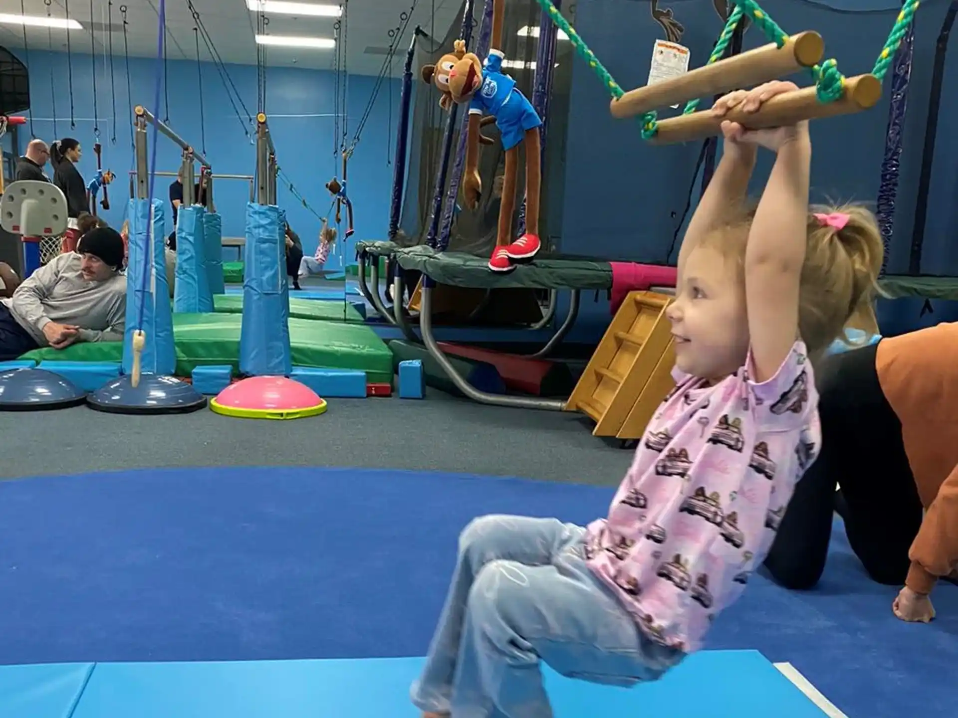 a person doing a handstand on a mat in a gym