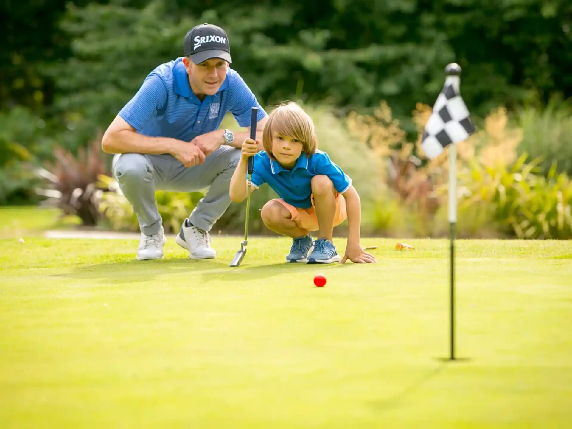 a person and a child playing golf