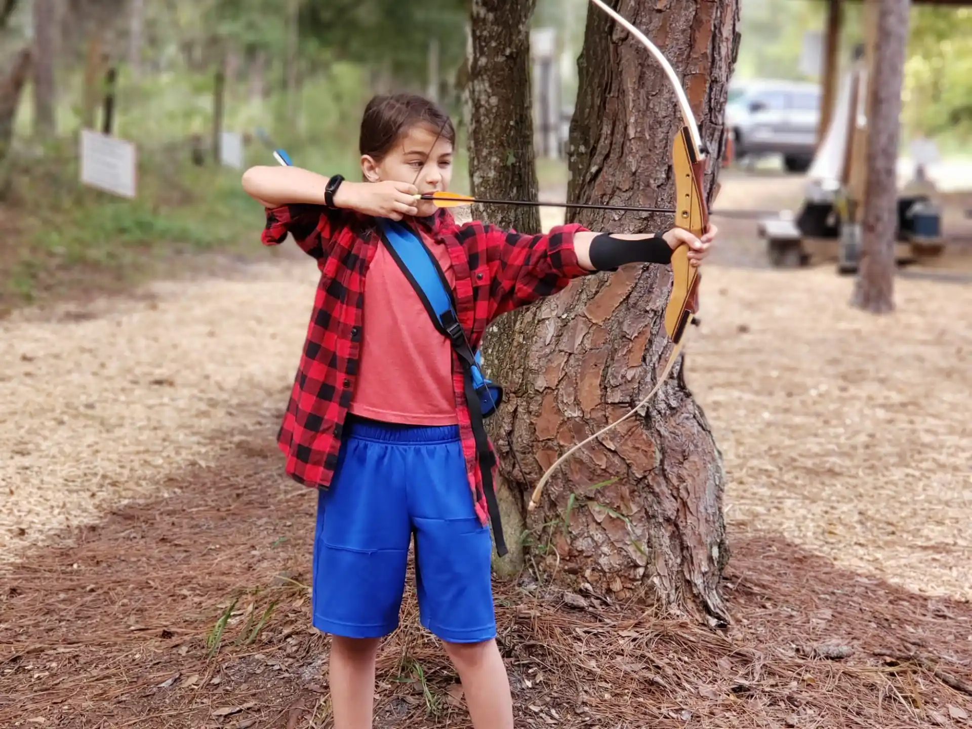 a boy holding a bow and arrow