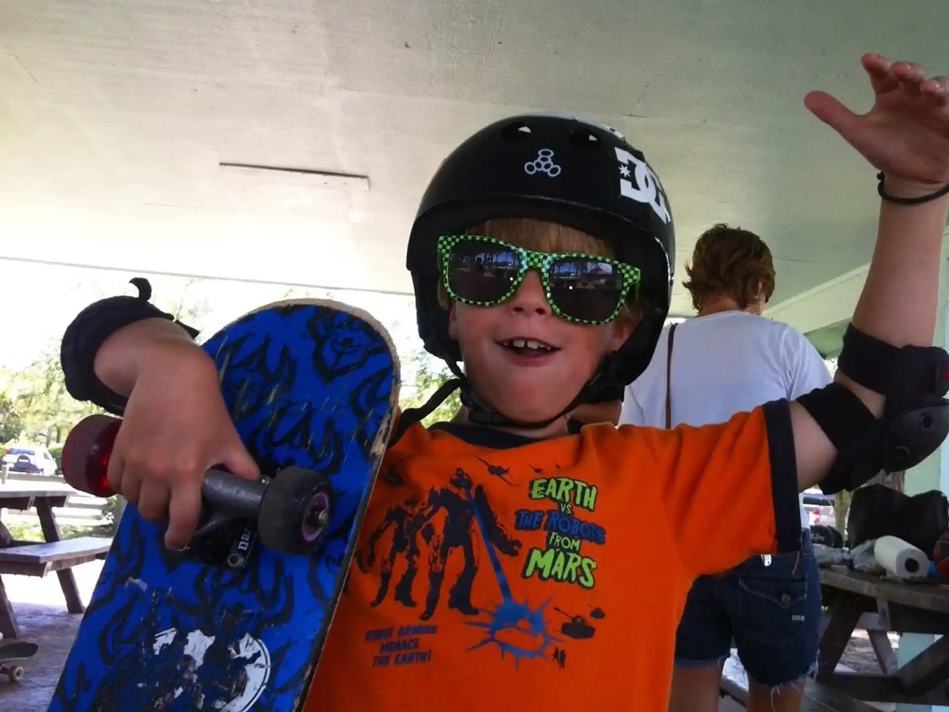 a kid holding a skateboard