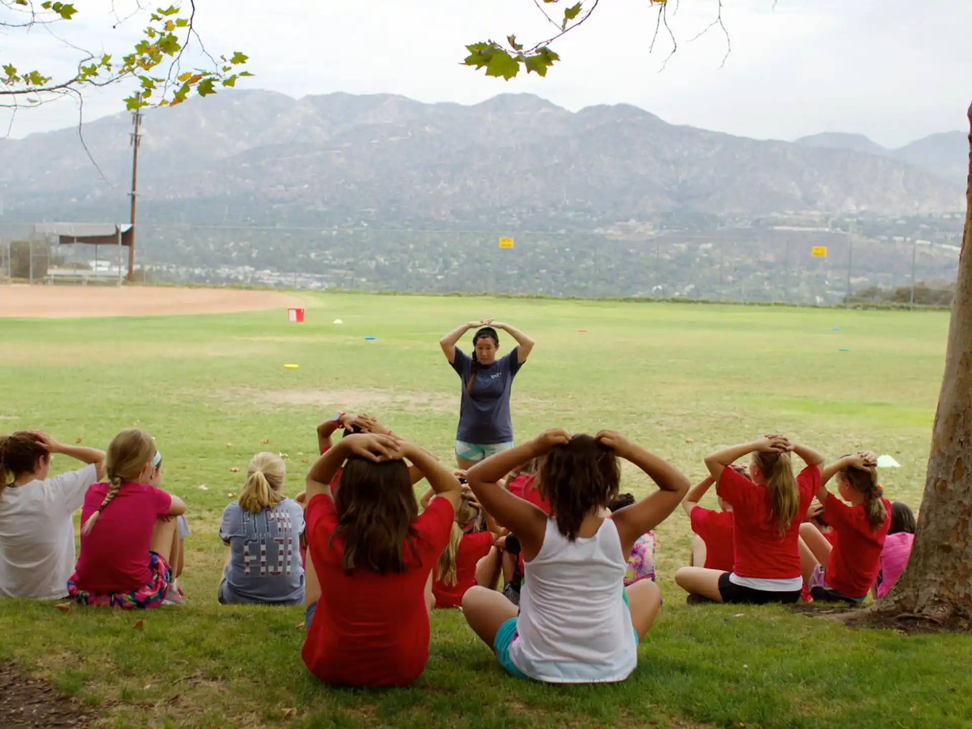 a group of people sitting on the grass