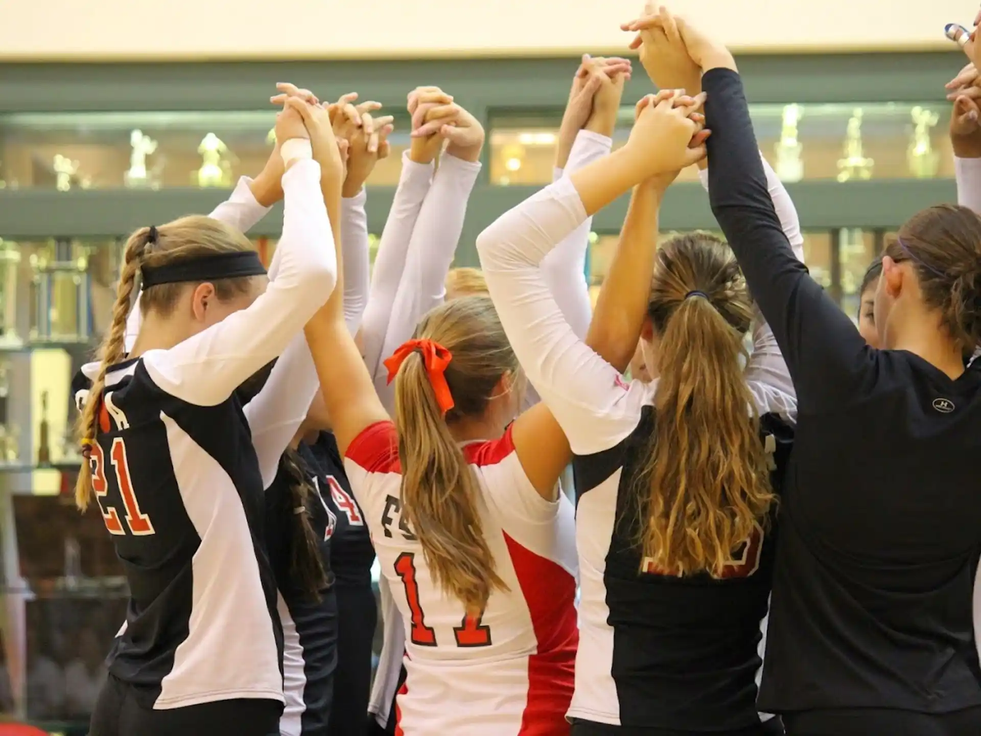 a group of women raising their hands