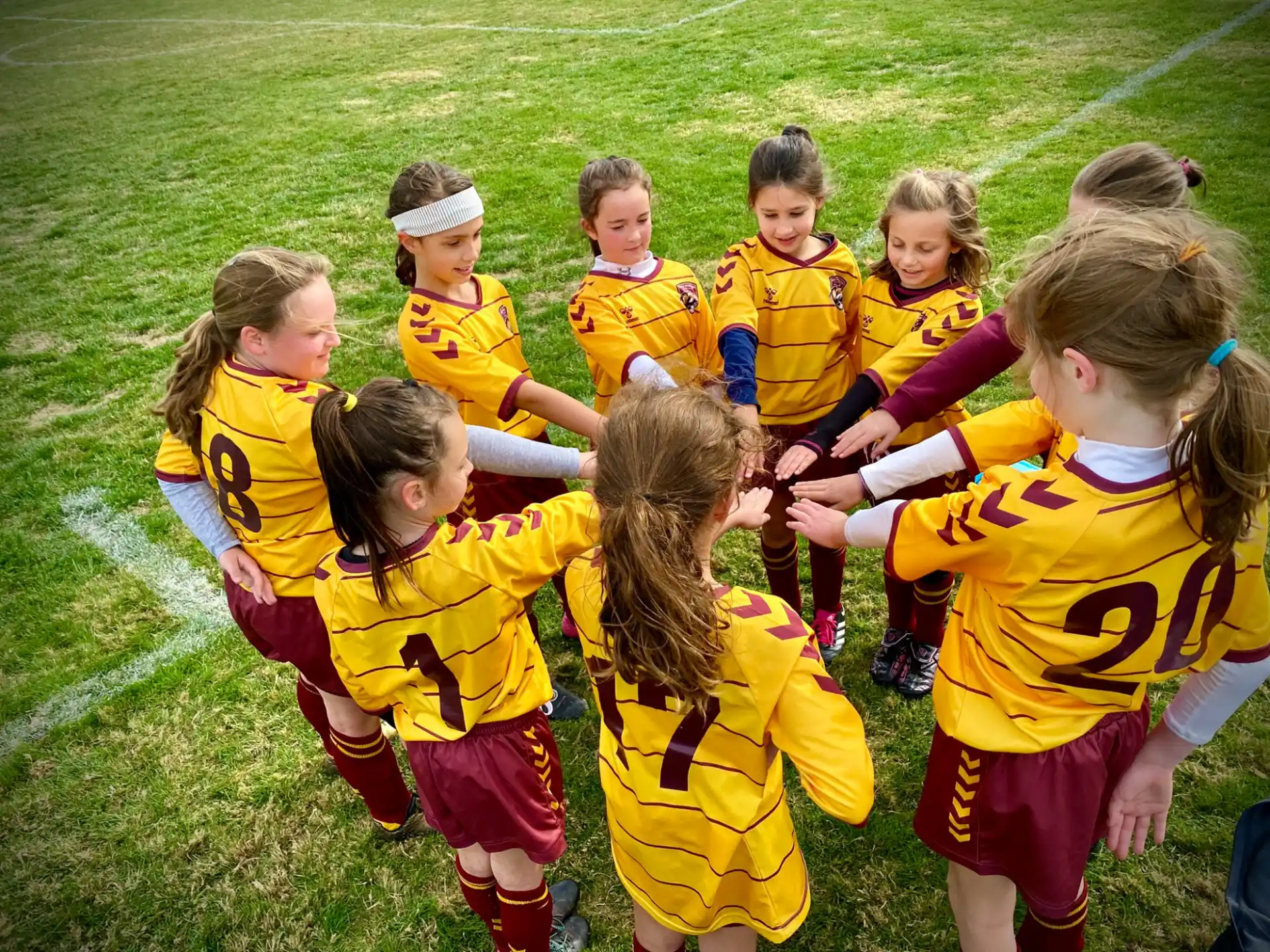 a group of children in yellow uniforms
