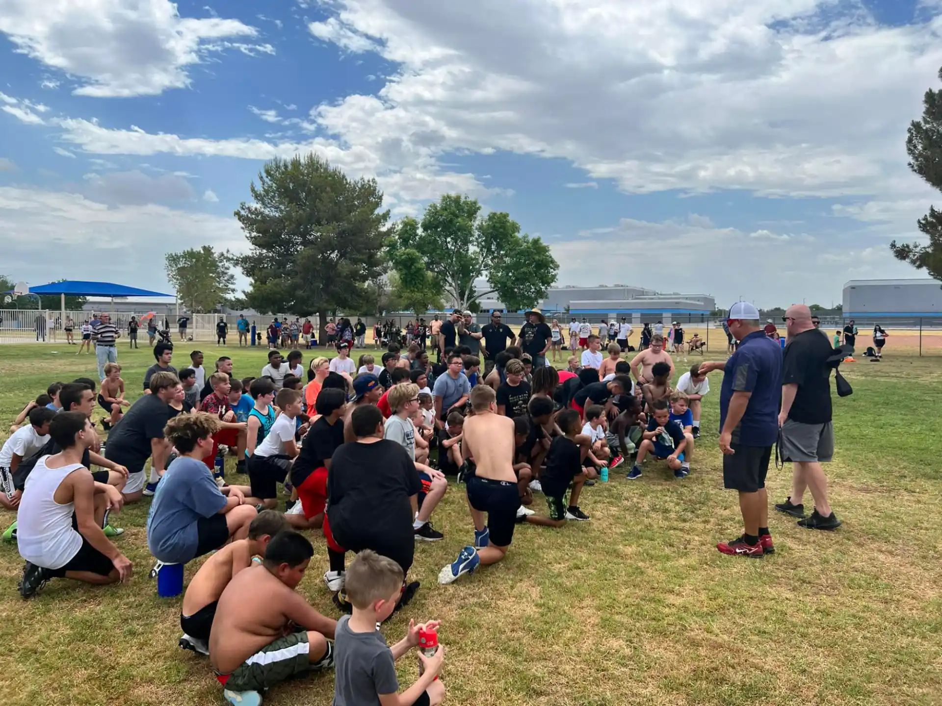a large group of people sitting on the grass