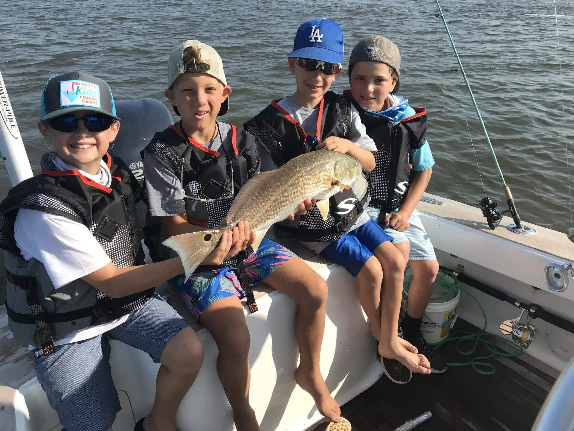 a group of people holding a fish