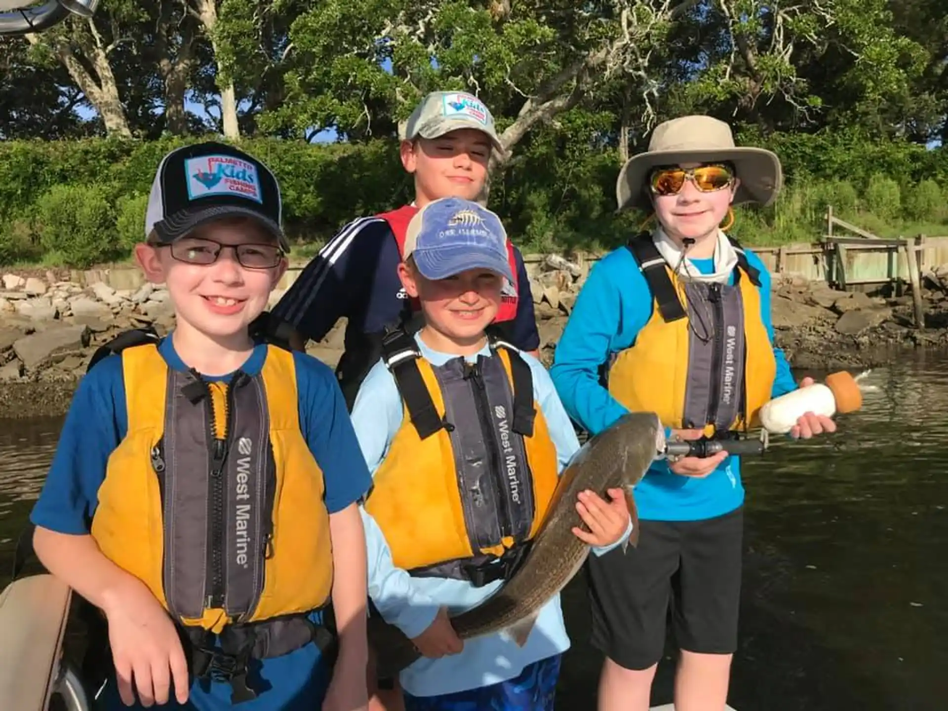 a group of people holding a fish