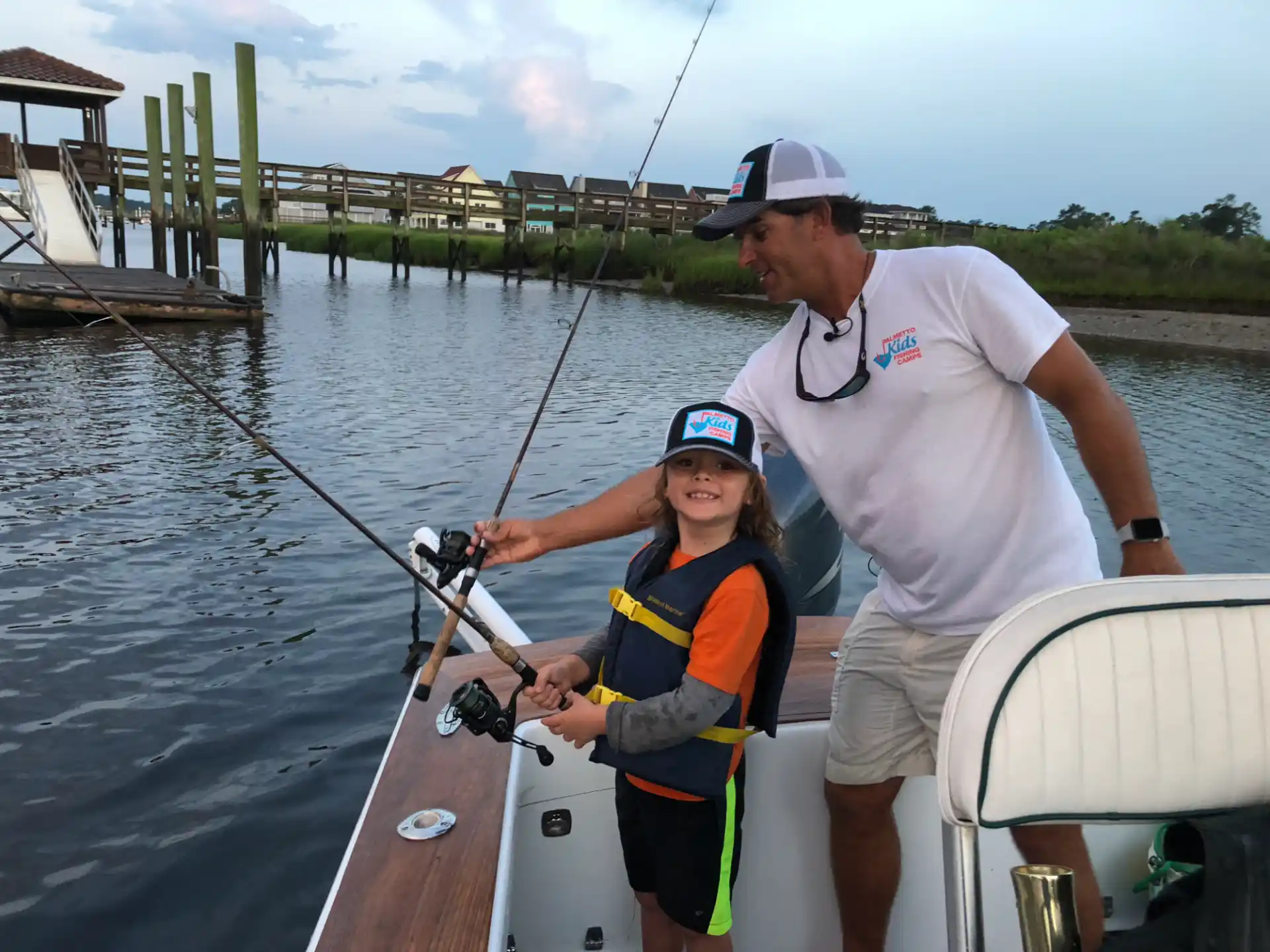 a man and a boy on a boat fishing