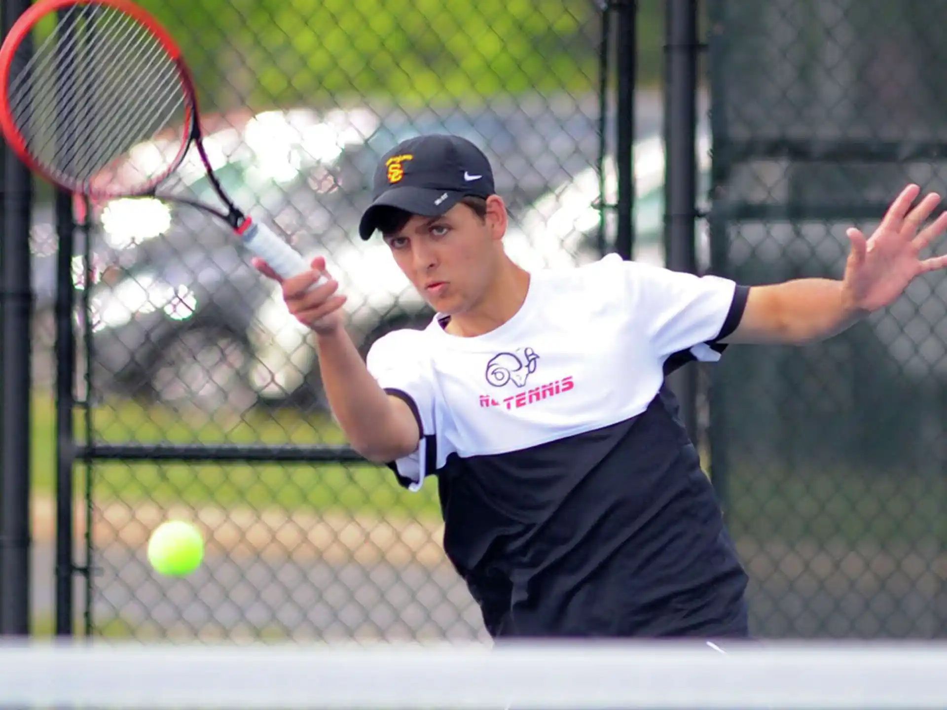 a person hitting a ball with a tennis racket