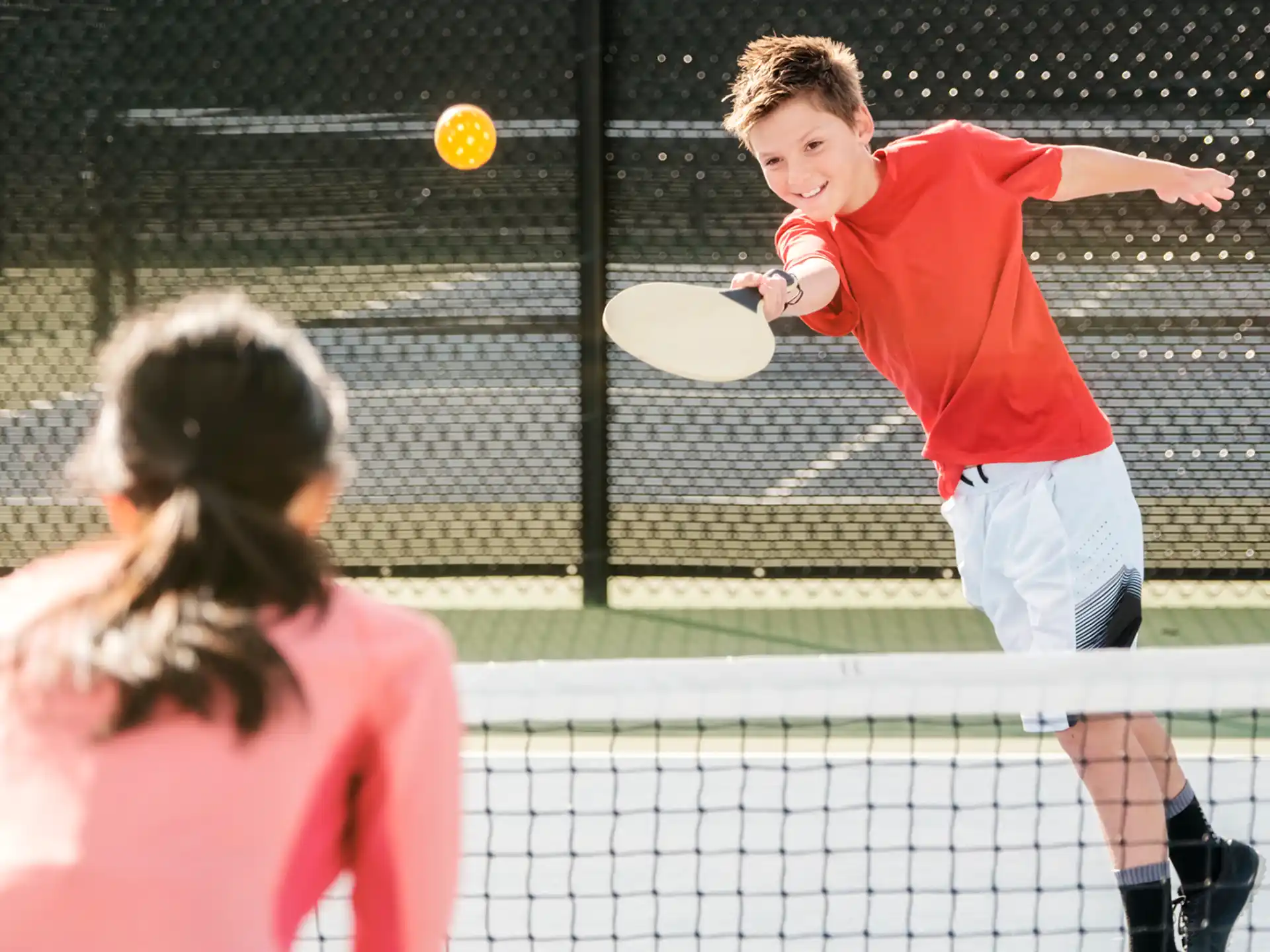 a person hitting a ball with a tennis racket