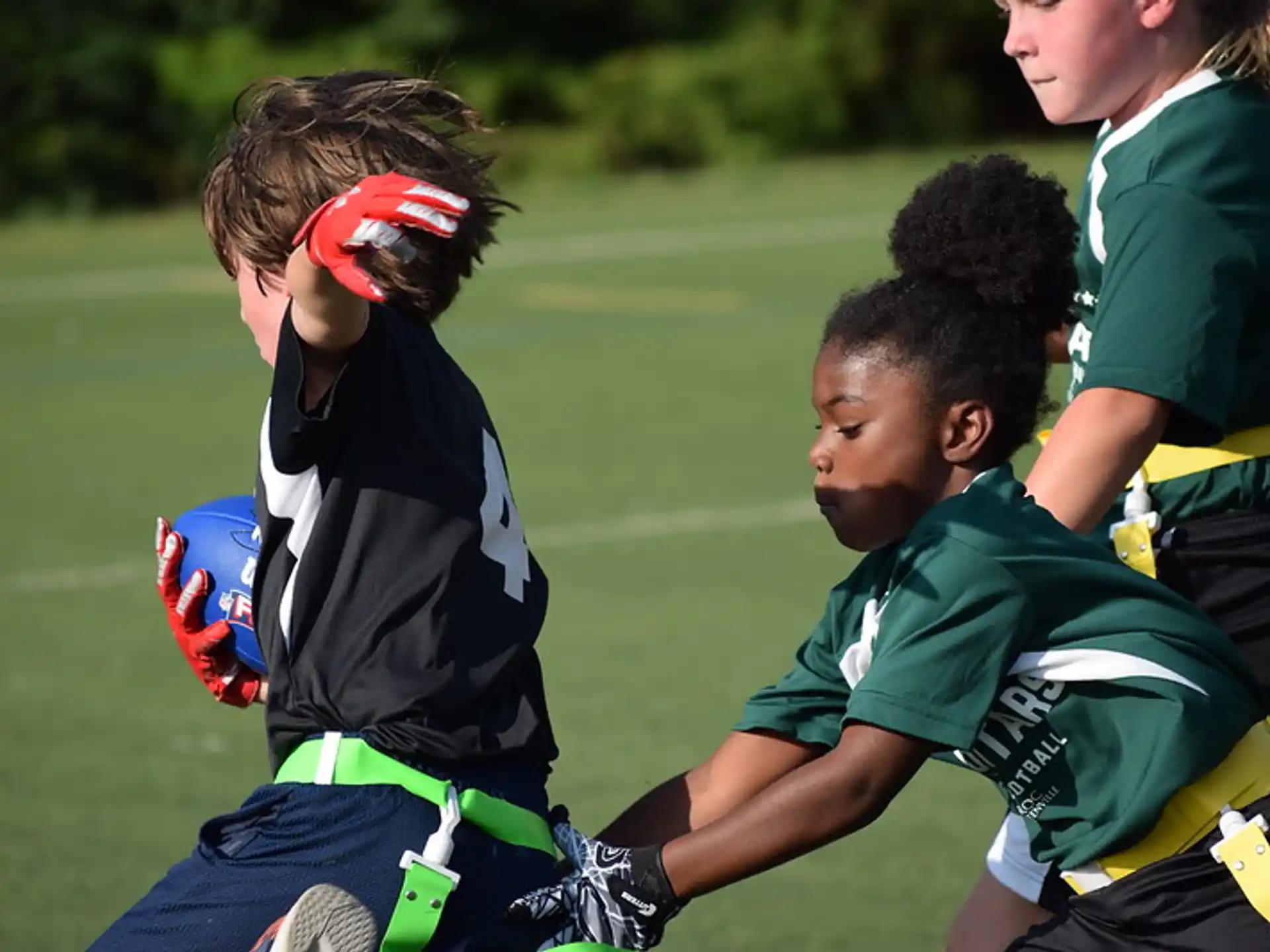 a group of kids playing football