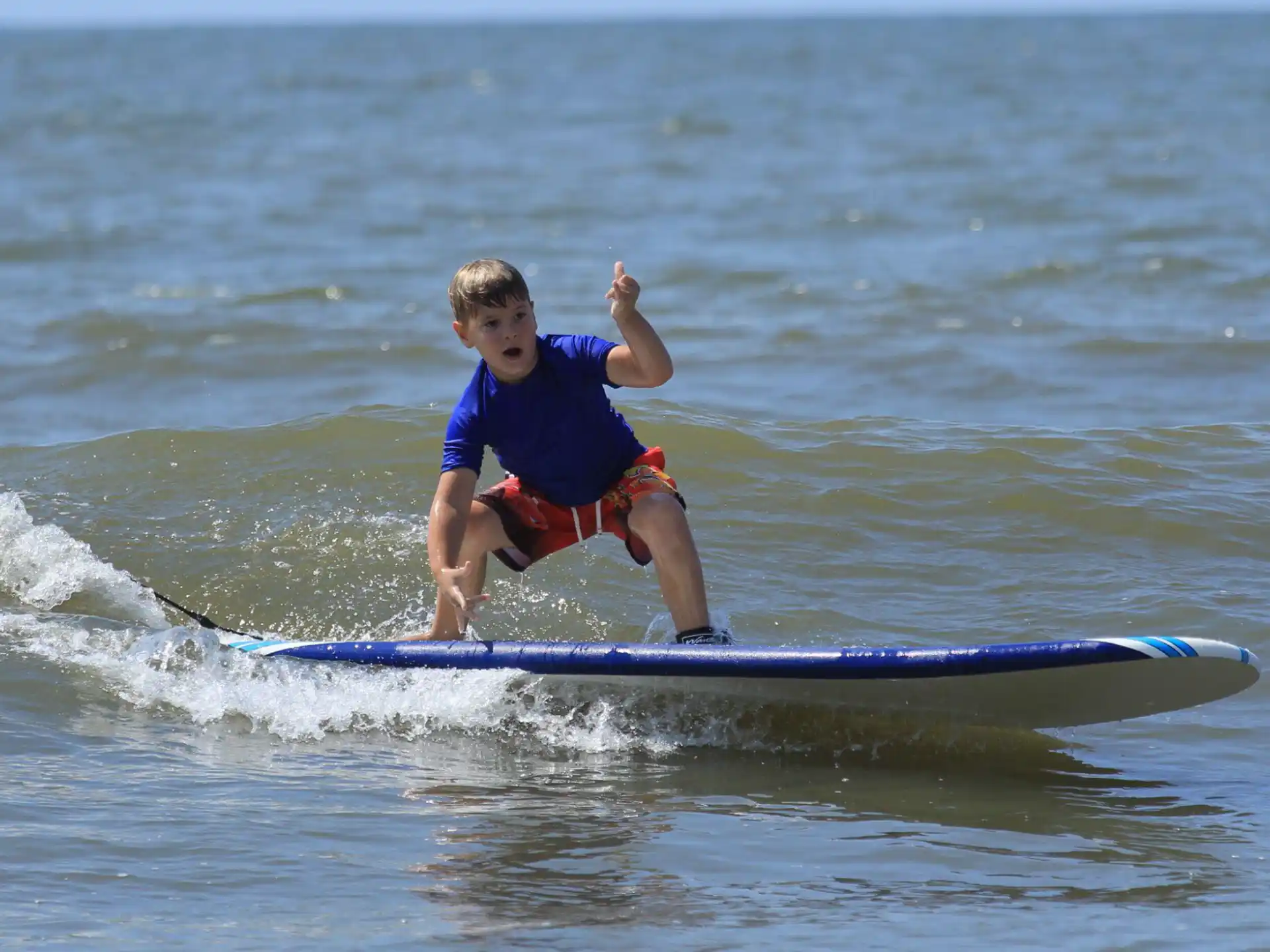 a boy riding a surfboard