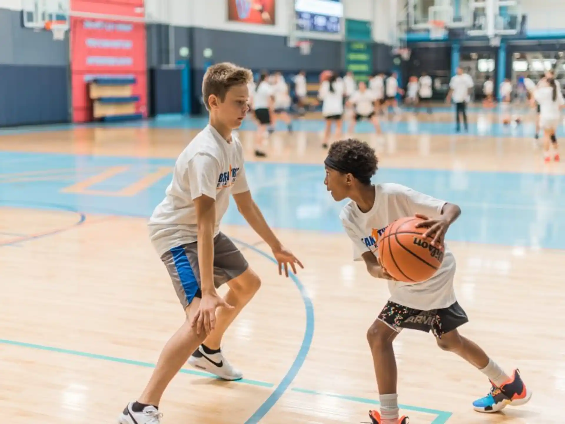 a couple of boys playing basketball