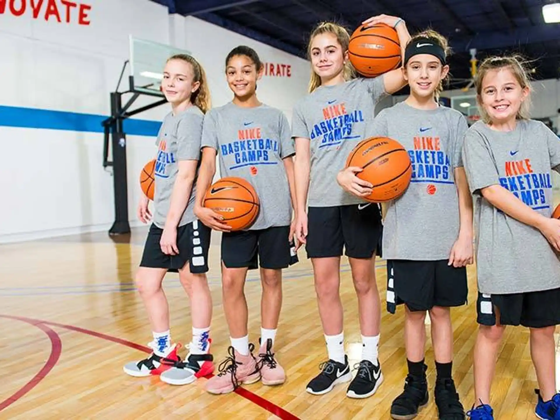 a group of kids holding basketballs