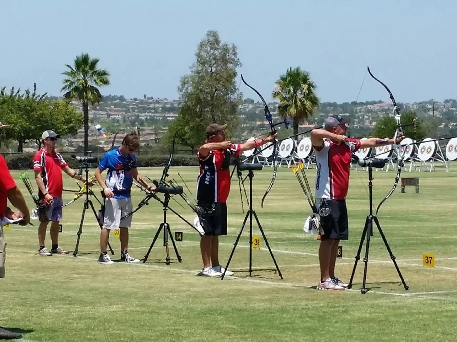 a group of people standing around a group of cameras