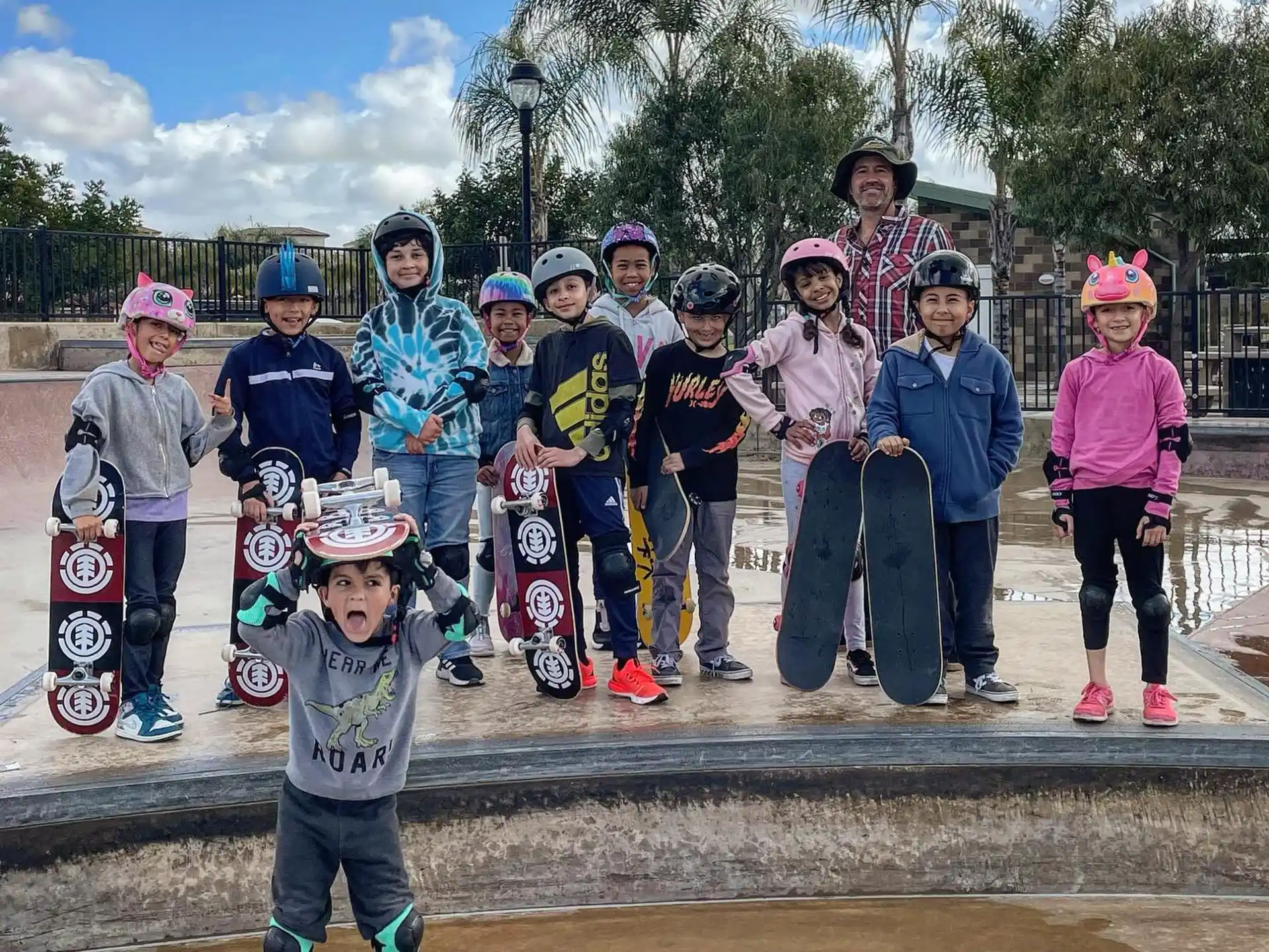 a group of kids posing for a picture with skateboards
