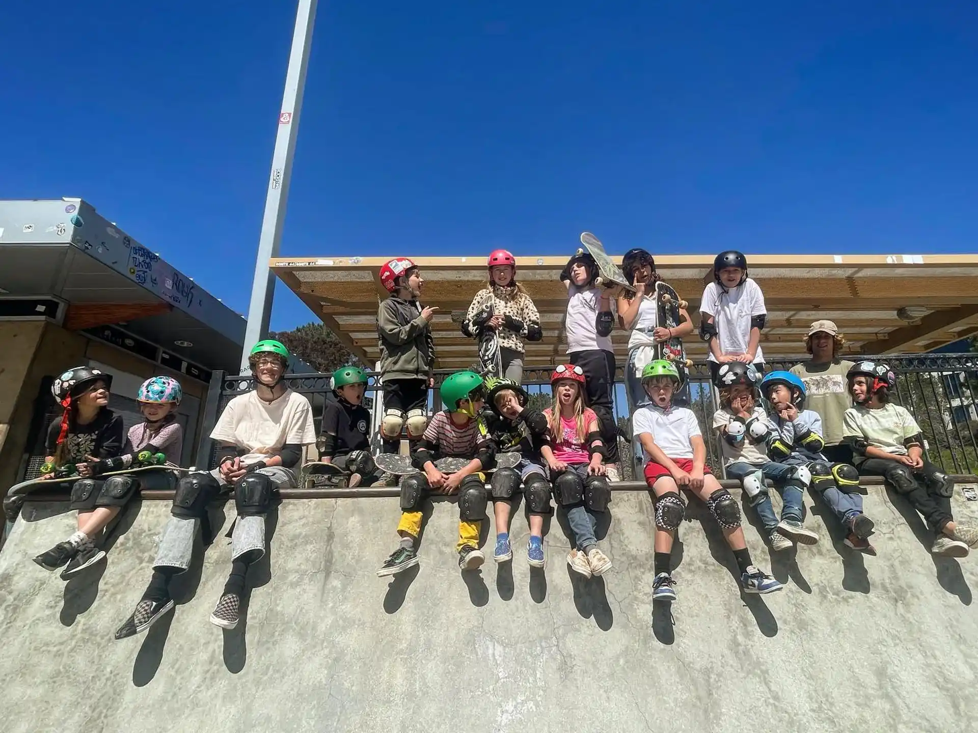 a group of people wearing helmets and roller skates