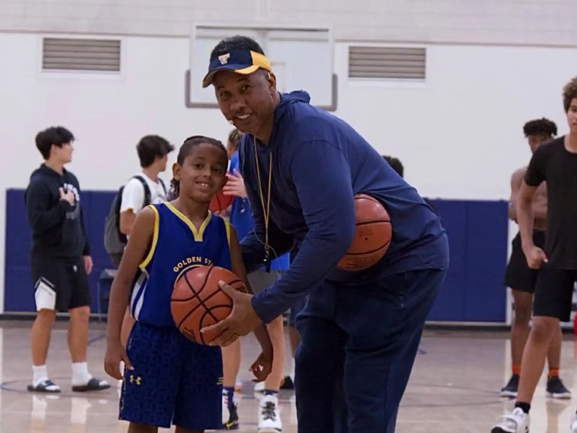 a person holding a basketball and a boy holding a basketball