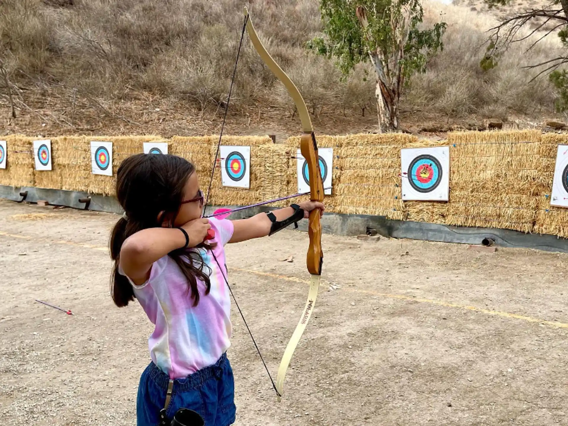 a girl holding a bow and arrow