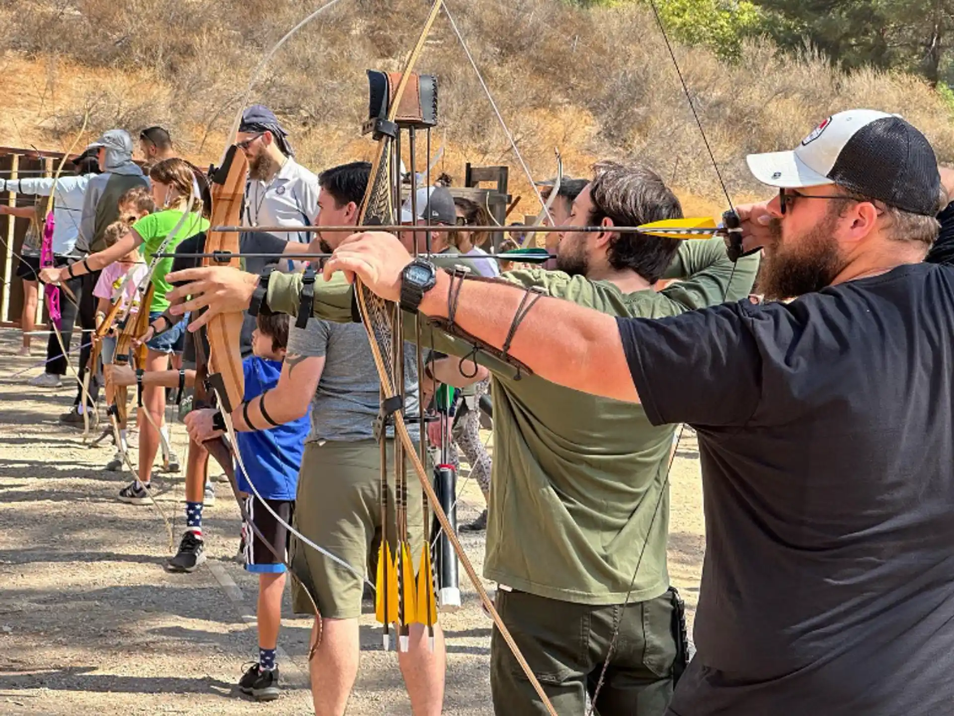 a group of people holding bows and arrows