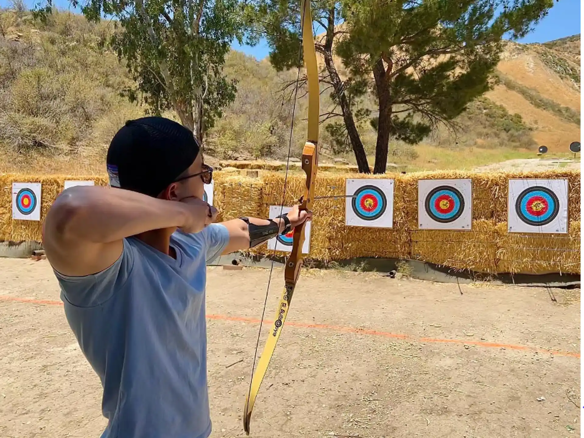 a man shooting a bow and arrow