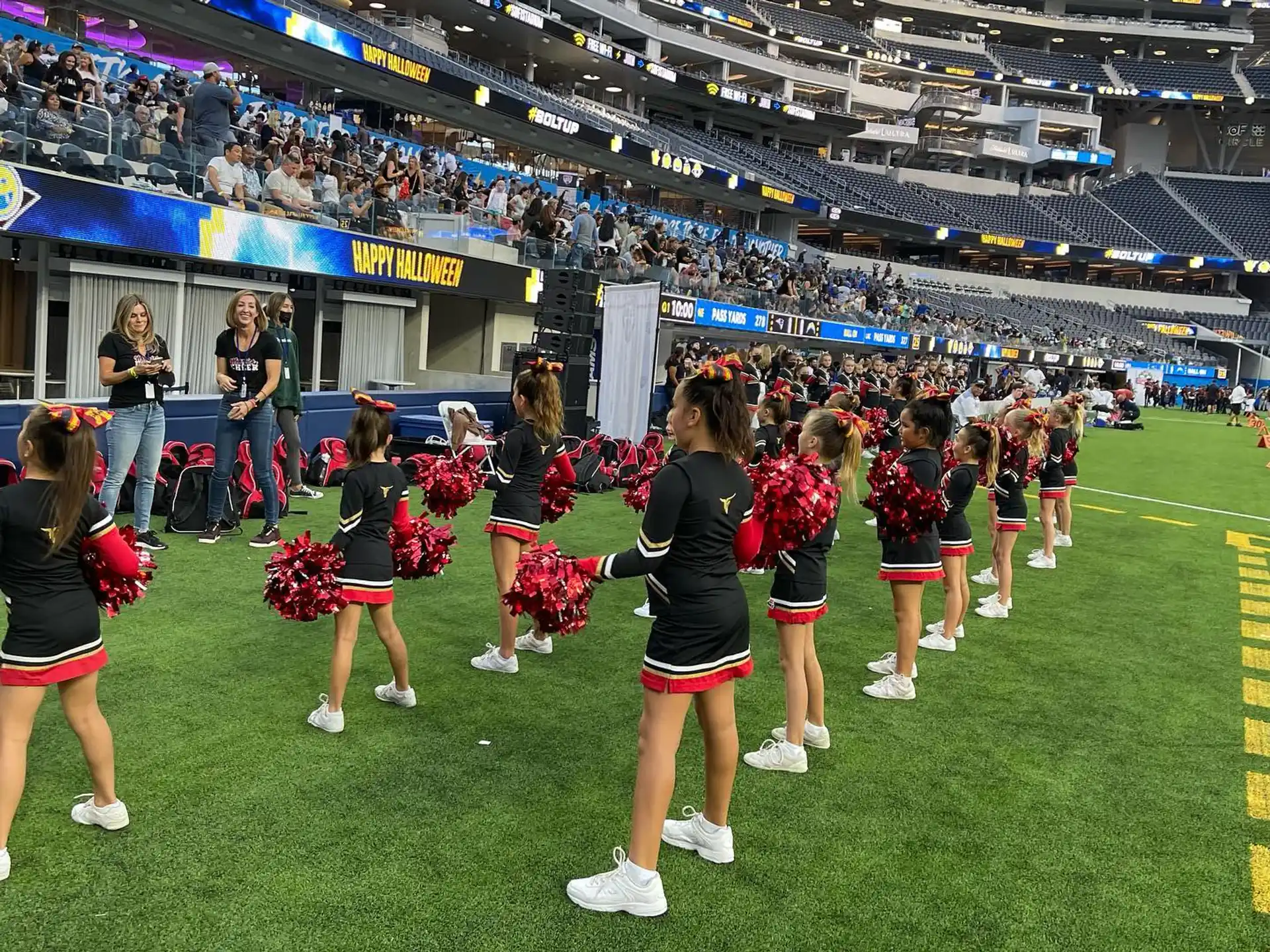 a group of cheerleaders on a football field