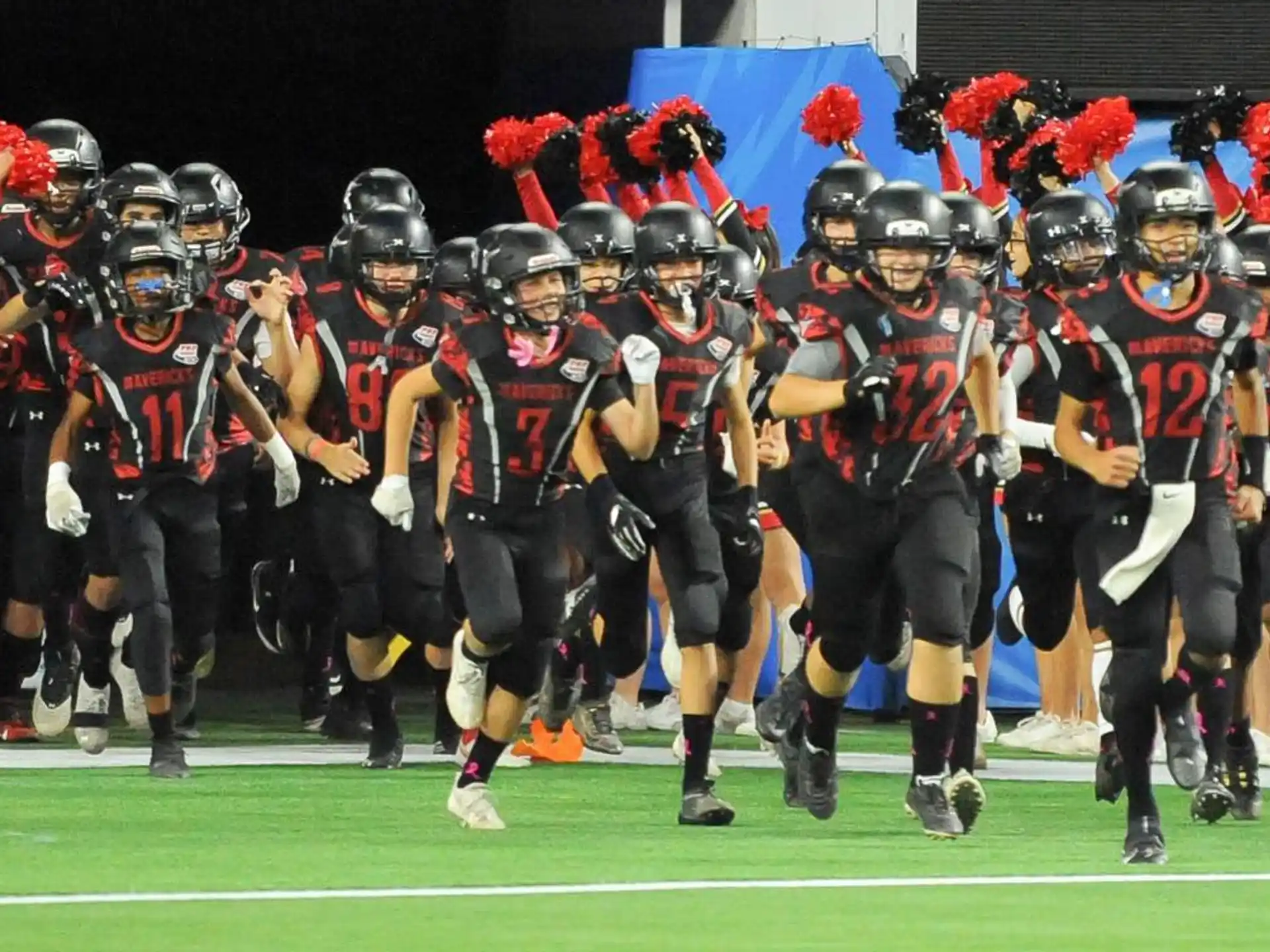 a group of football players walking on a field