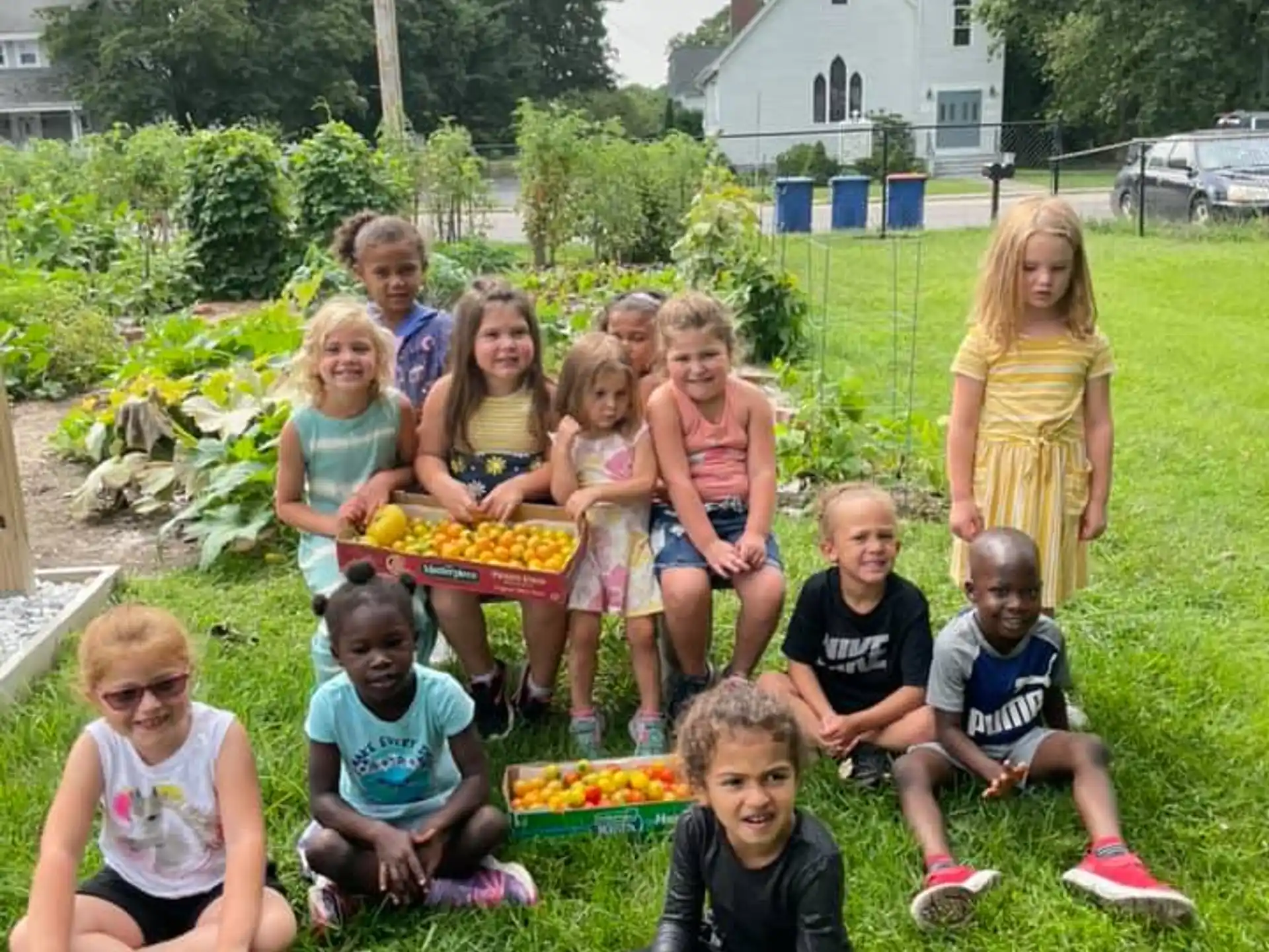 a group of children sitting on the grass