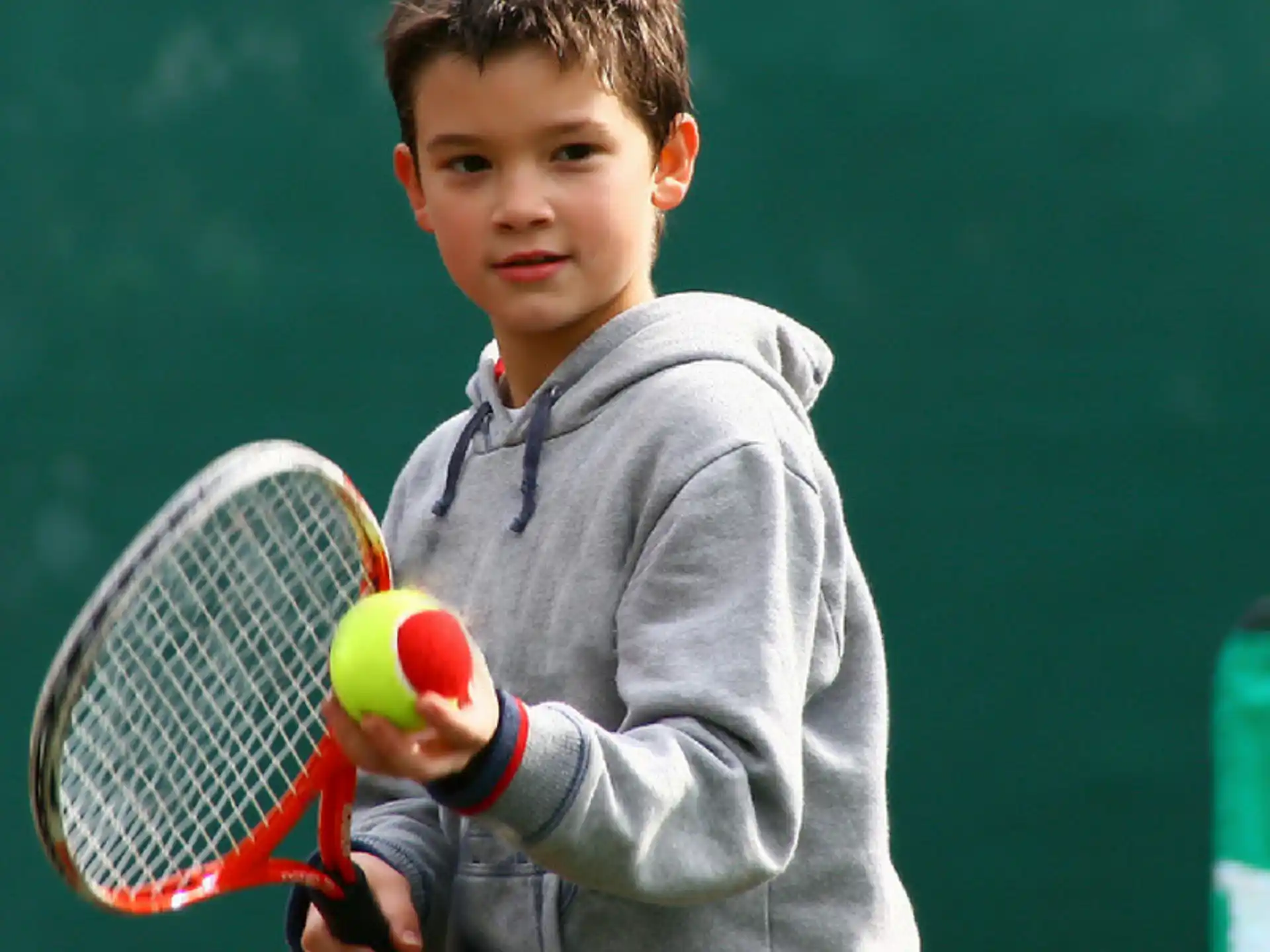 a boy holding a tennis racket