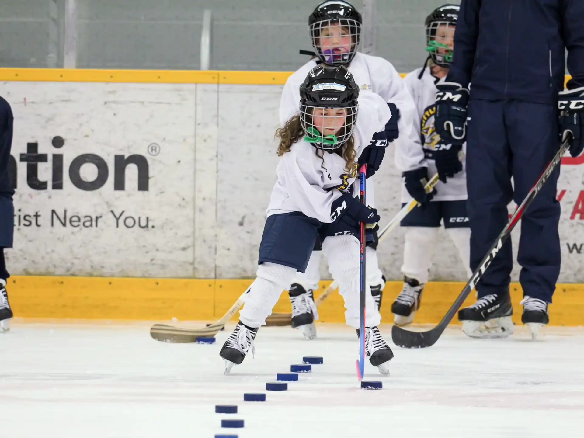 a group of people playing hockey