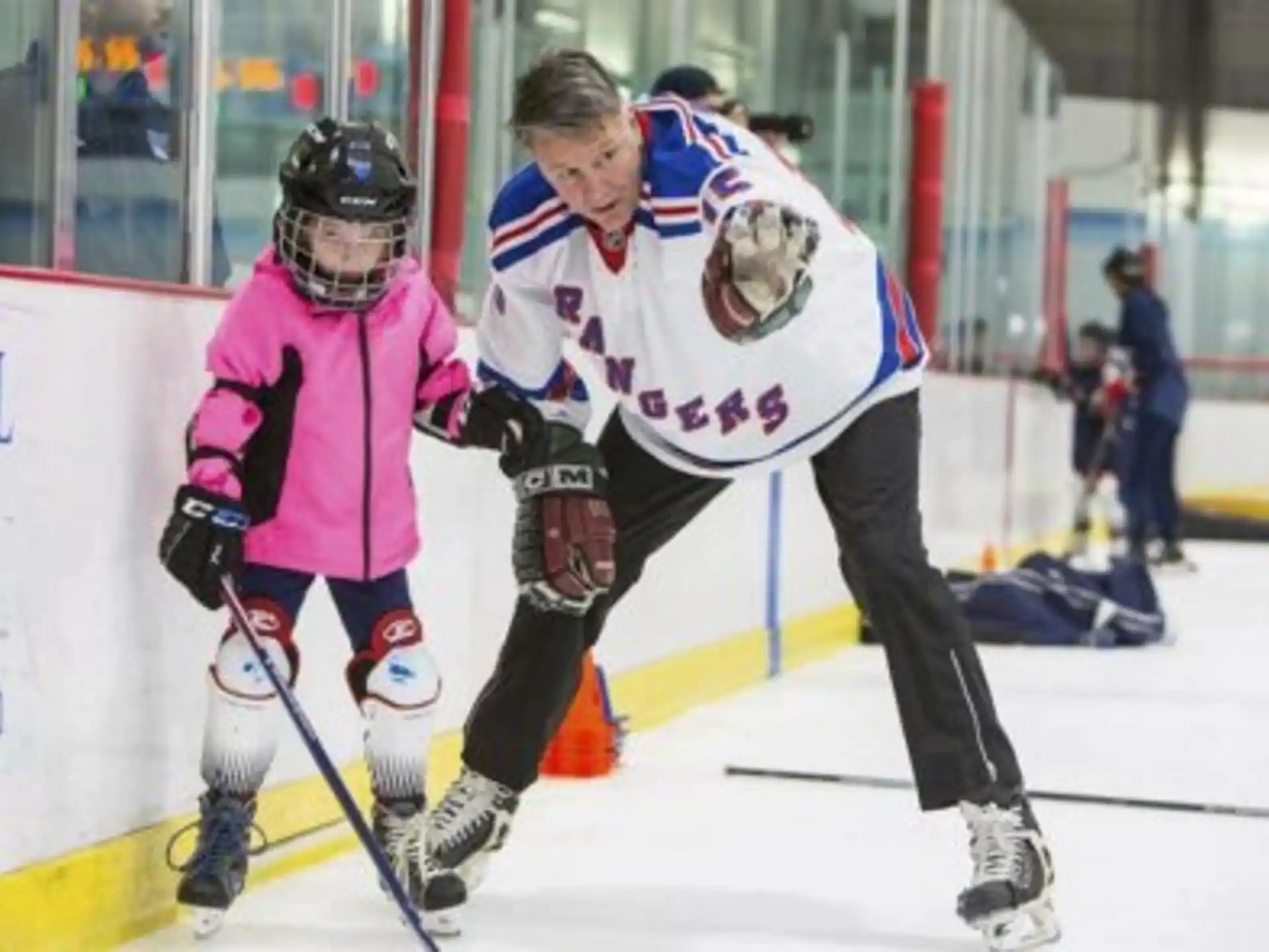 a man and a woman playing hockey