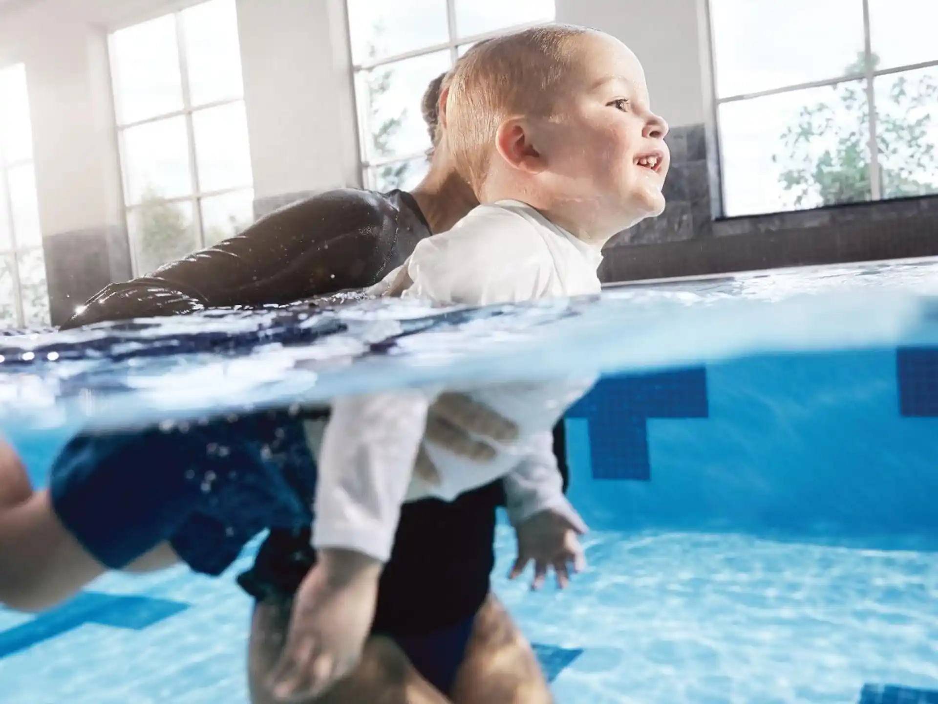 a boy holding a dolphin