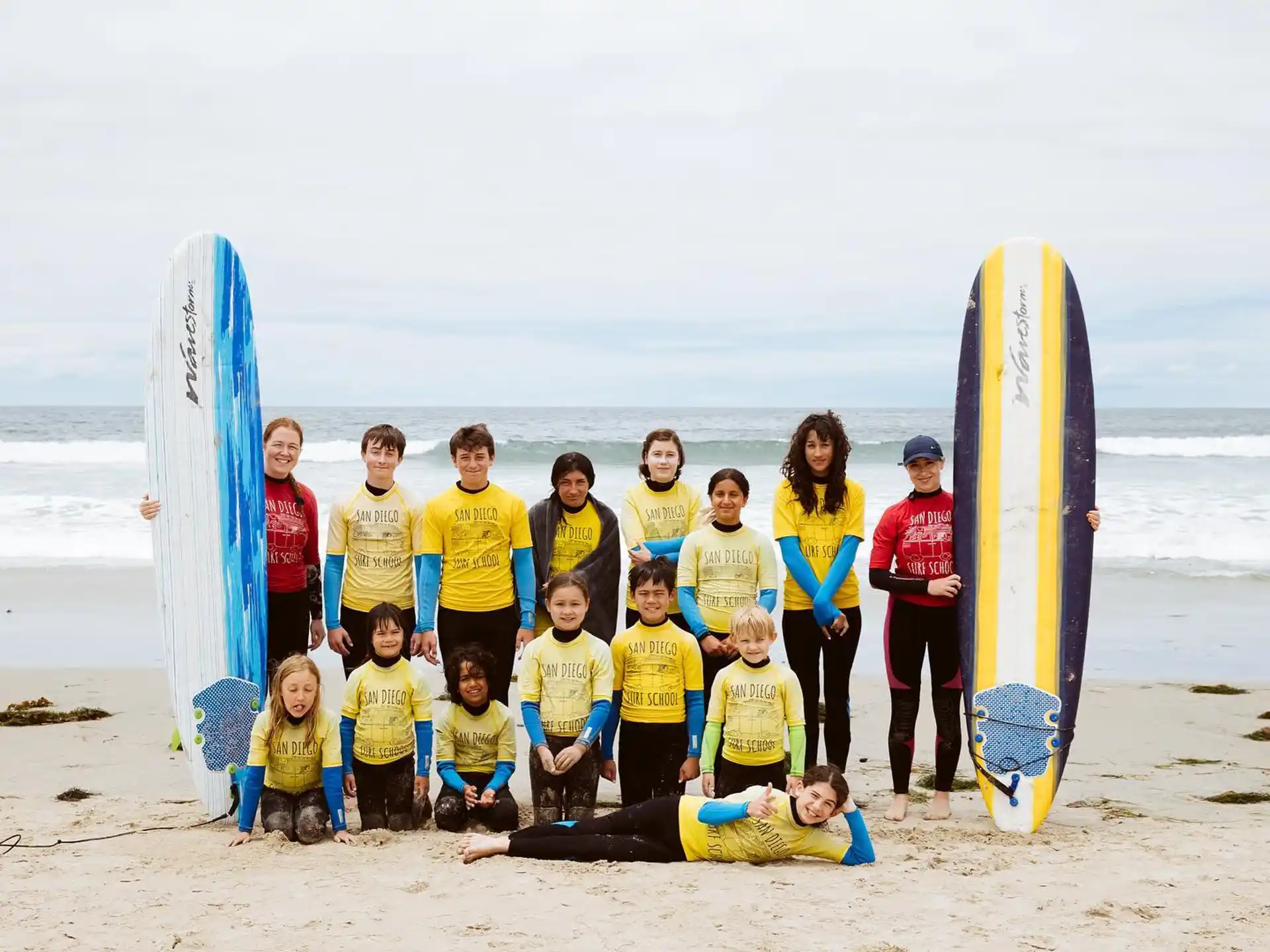 a group of people posing for a photo on a beach