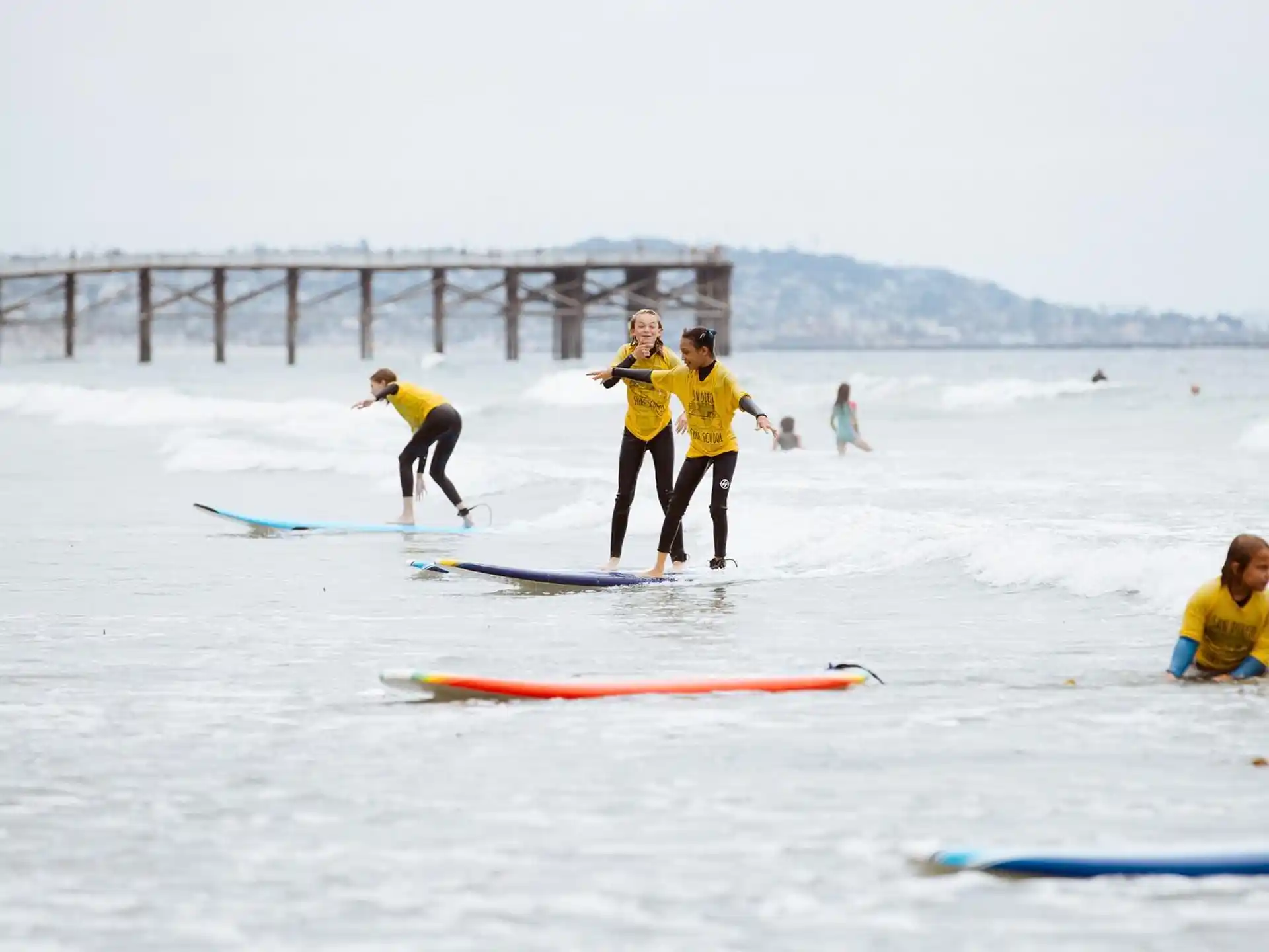 a group of people surfing on the sea