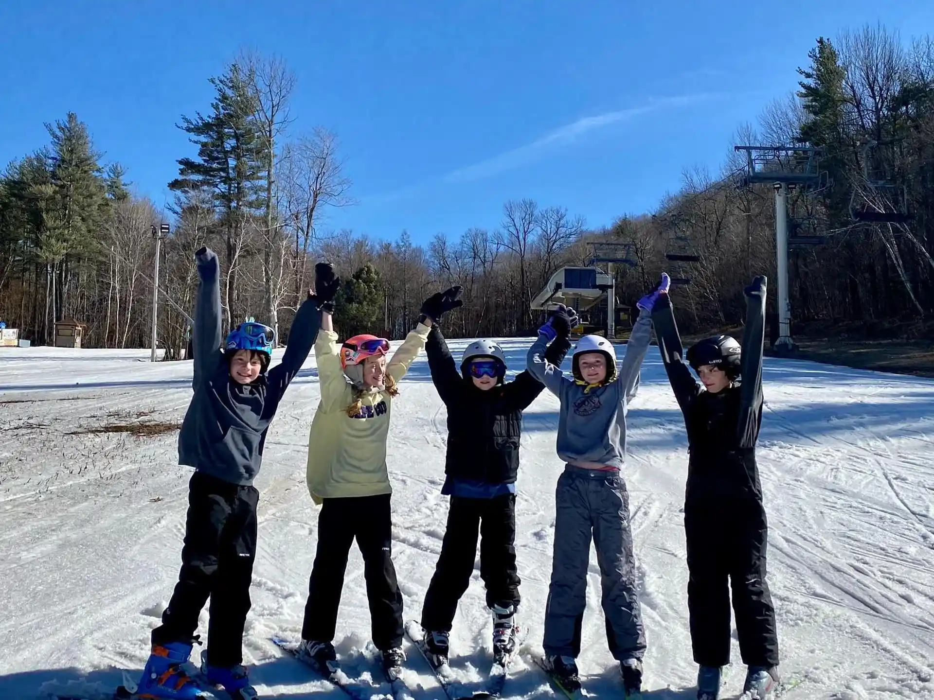 a group of people pose on snow skis
