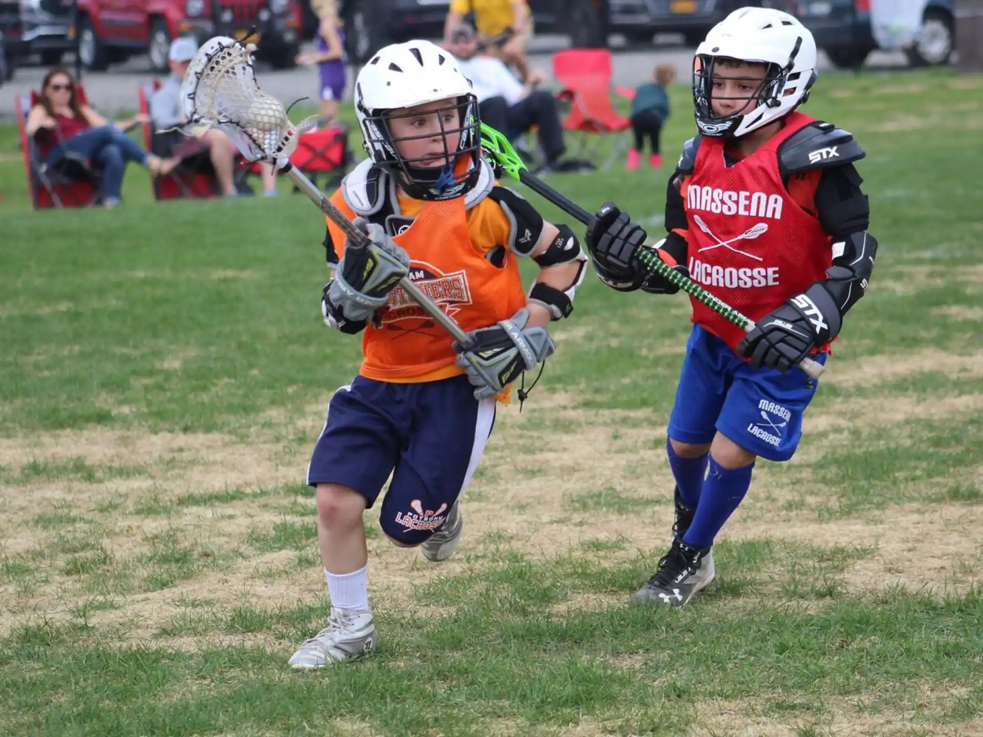 two kids playing lacrosse